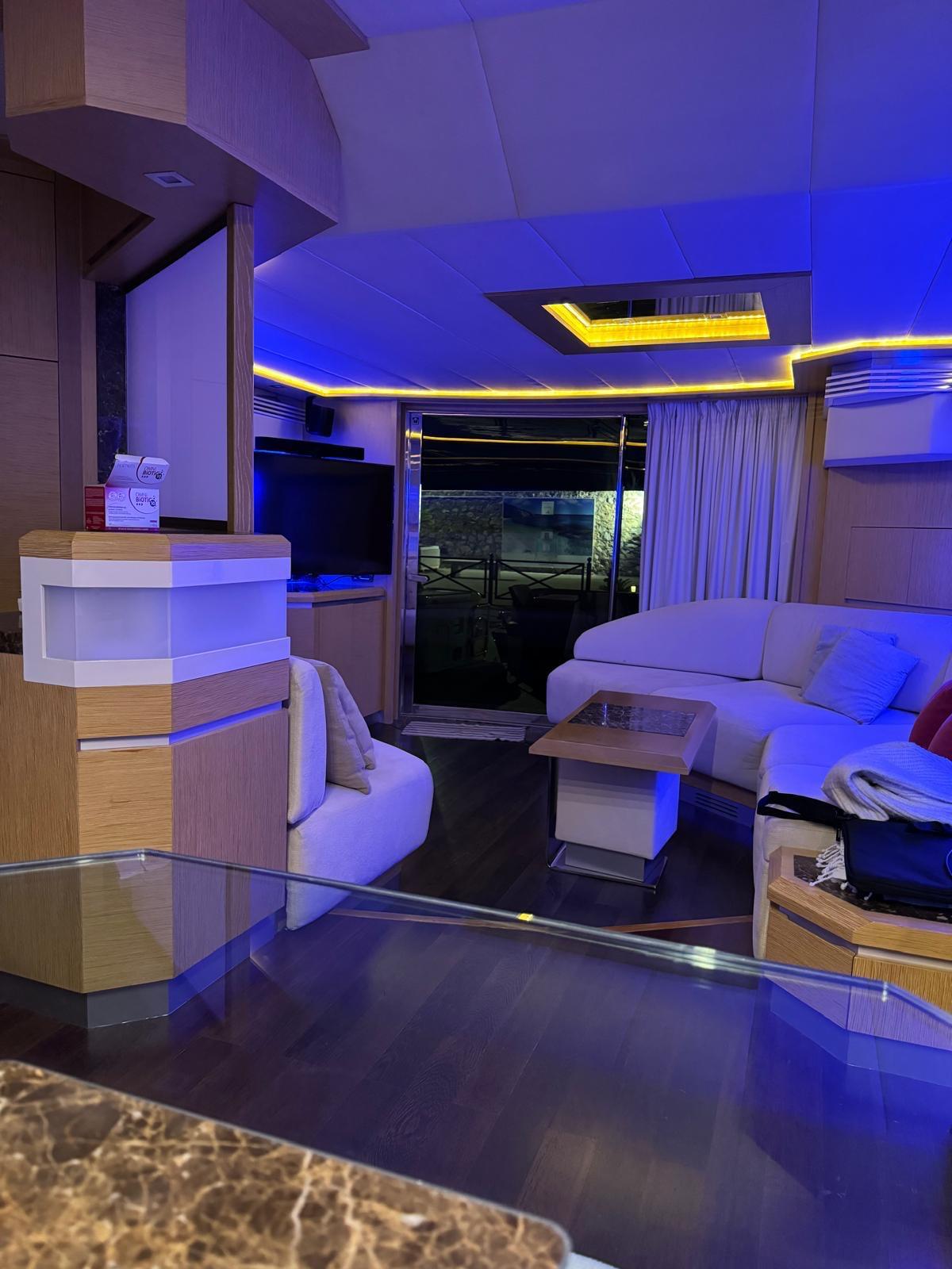 Luxurious interior of a 2008 Dominator 680 yacht with modern lighting and comfortable seating.