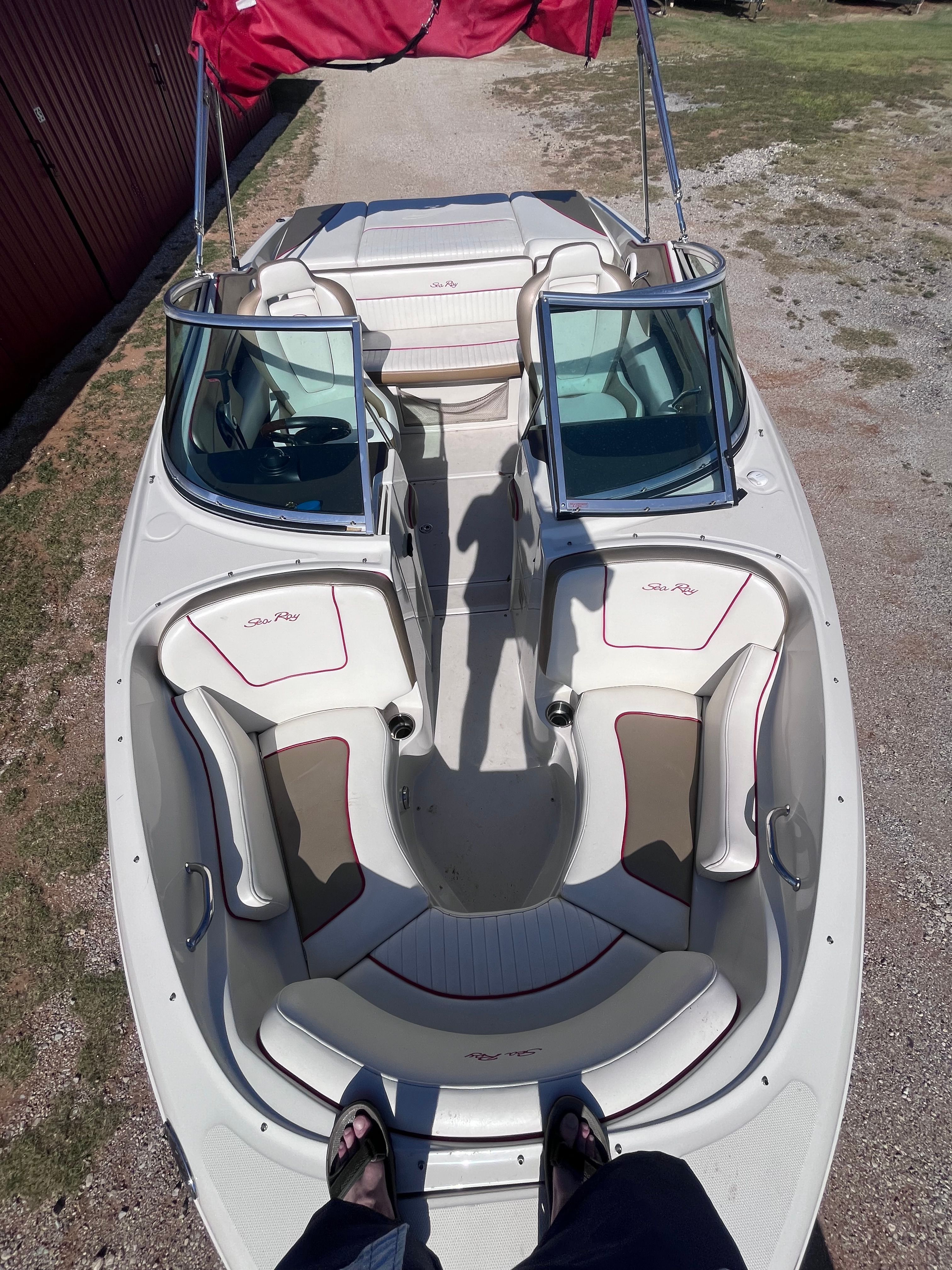 The image shows the interior of a 2007 Sea Ray 210 Select boat with white seating.