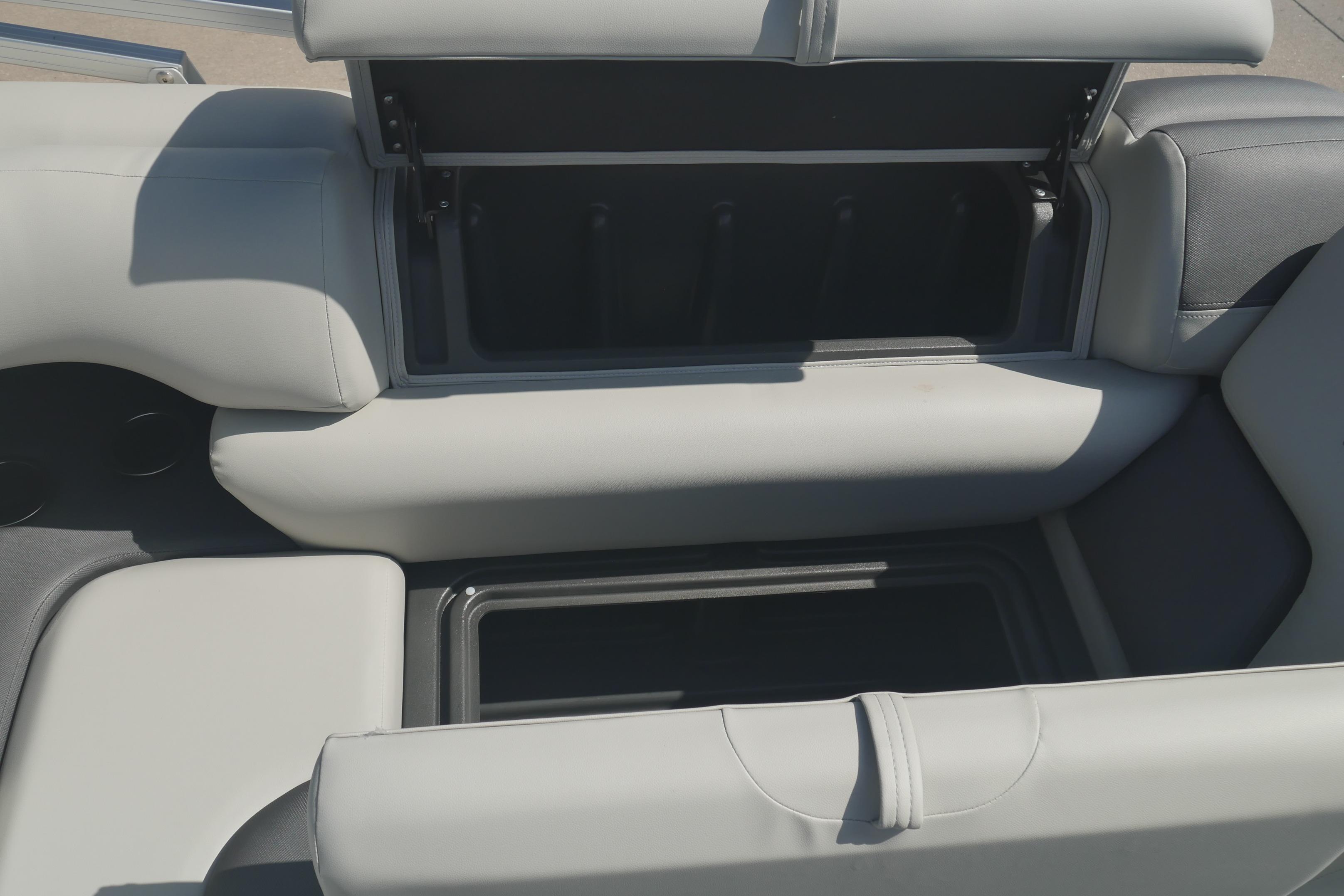 2026 Sun Tracker Fishin' Barge 20 DLX boat seat storage compartments open.