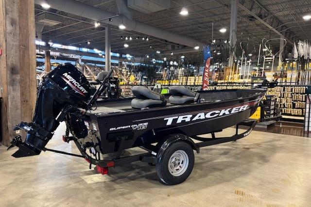 2026 Tracker Super Guide V-16 T boat displayed indoors with Mercury engine.