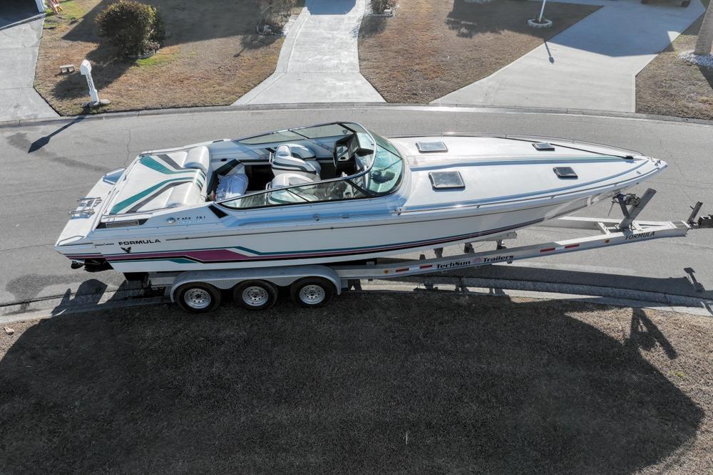 1989 Formula 292 SR-1 speedboat on trailer, parked on a residential street.