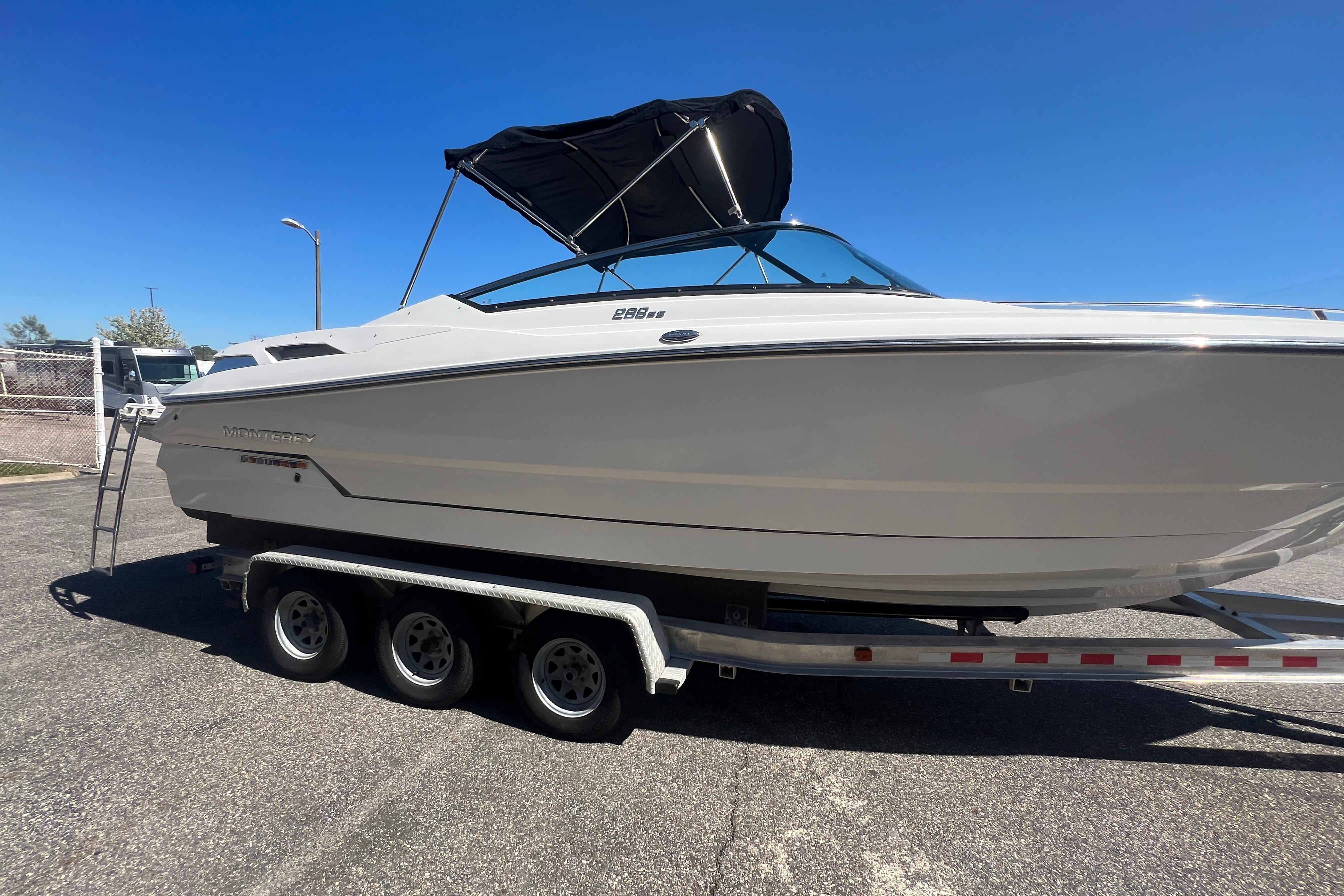2017 Monterey 298SS Super Sport boat on a trailer under clear blue sky.