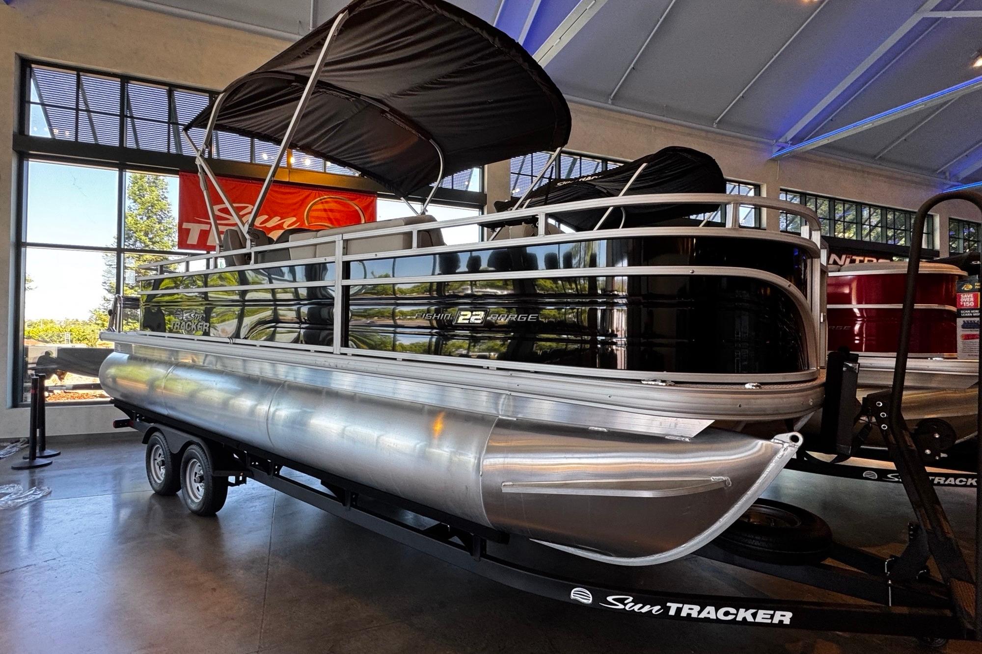 2026 Sun Tracker Fishin' Barge 22 XP3 in a showroom.