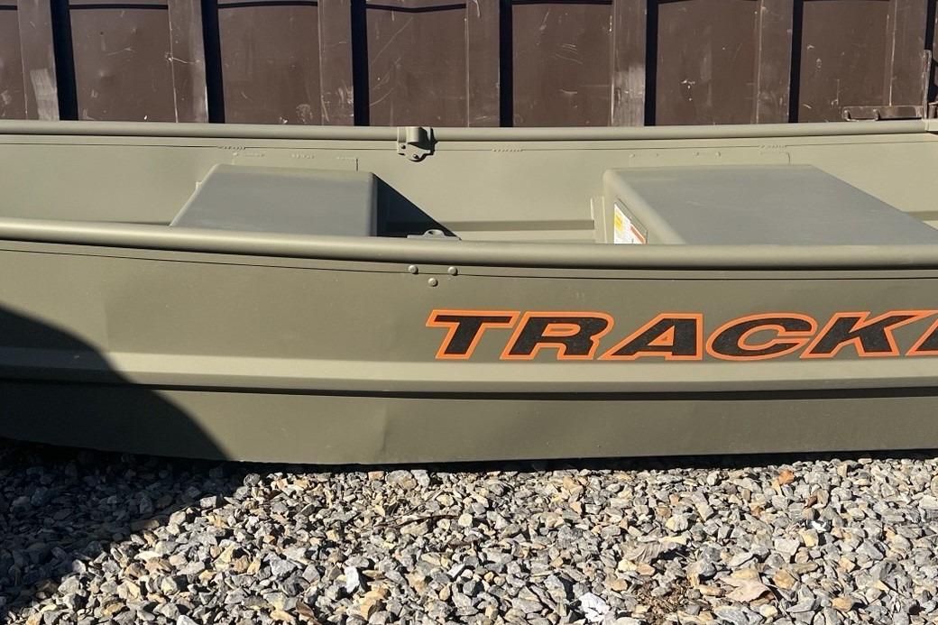 2026 Tracker Grizzly 10 Jon boat on gravel, featuring bold orange lettering.