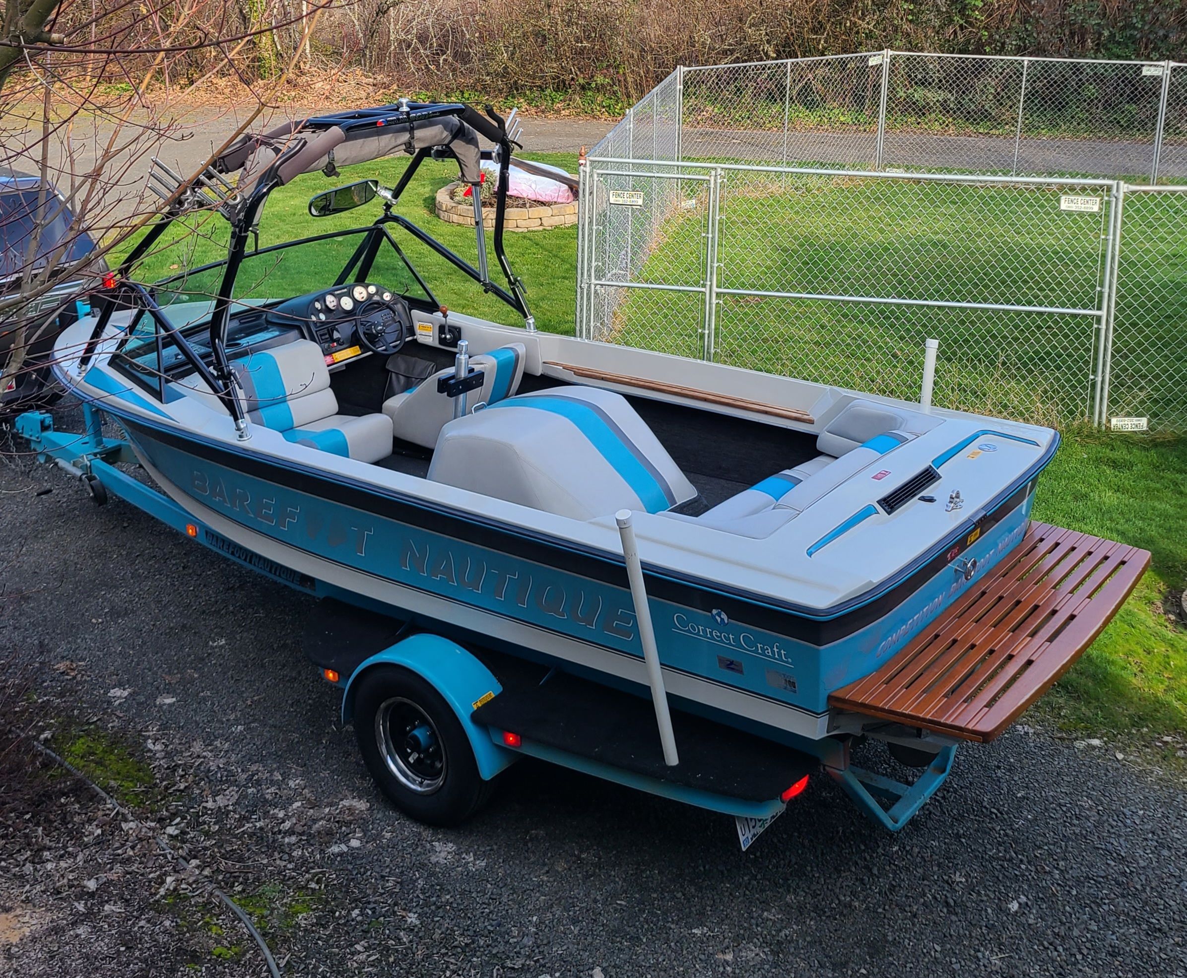 A 1990 Correct Craft Barefoot Nautique on a trailer, featuring blue and gray paint.