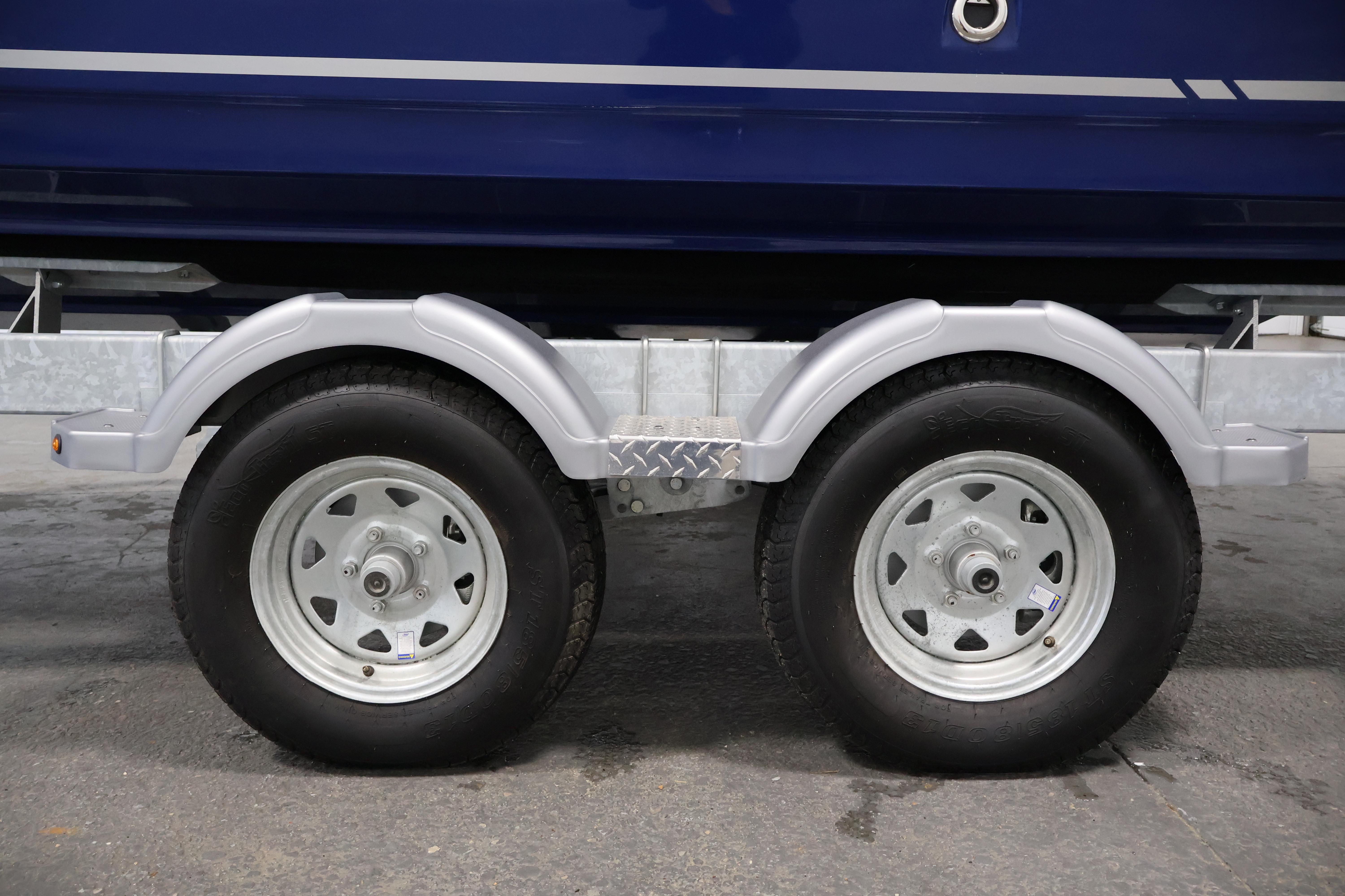 2026 Bayliner VR6 Bowrider I/O trailer wheels on a concrete surface.