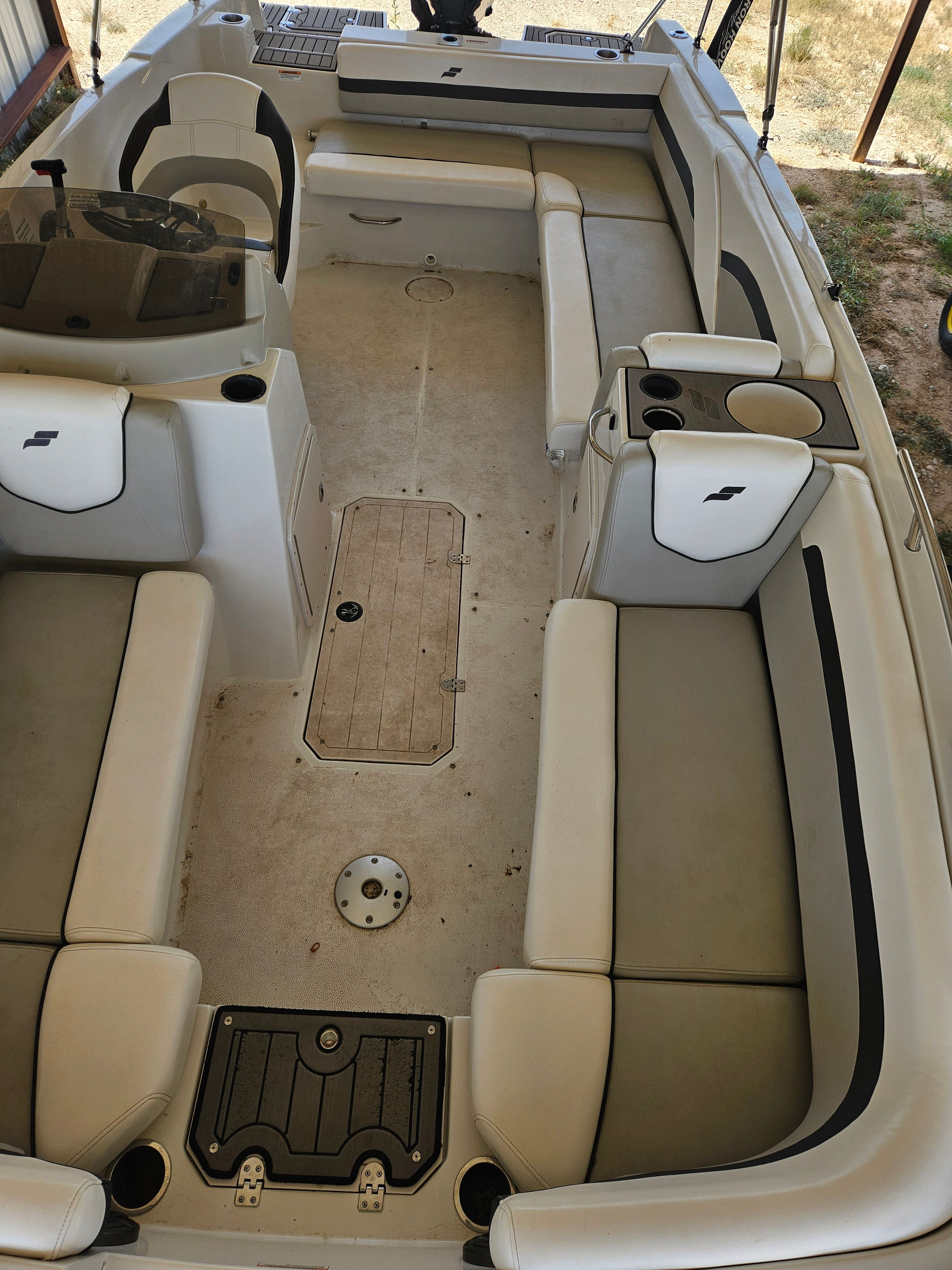 Interior view of a Starcraft SVX211 boat with seating and cup holders.