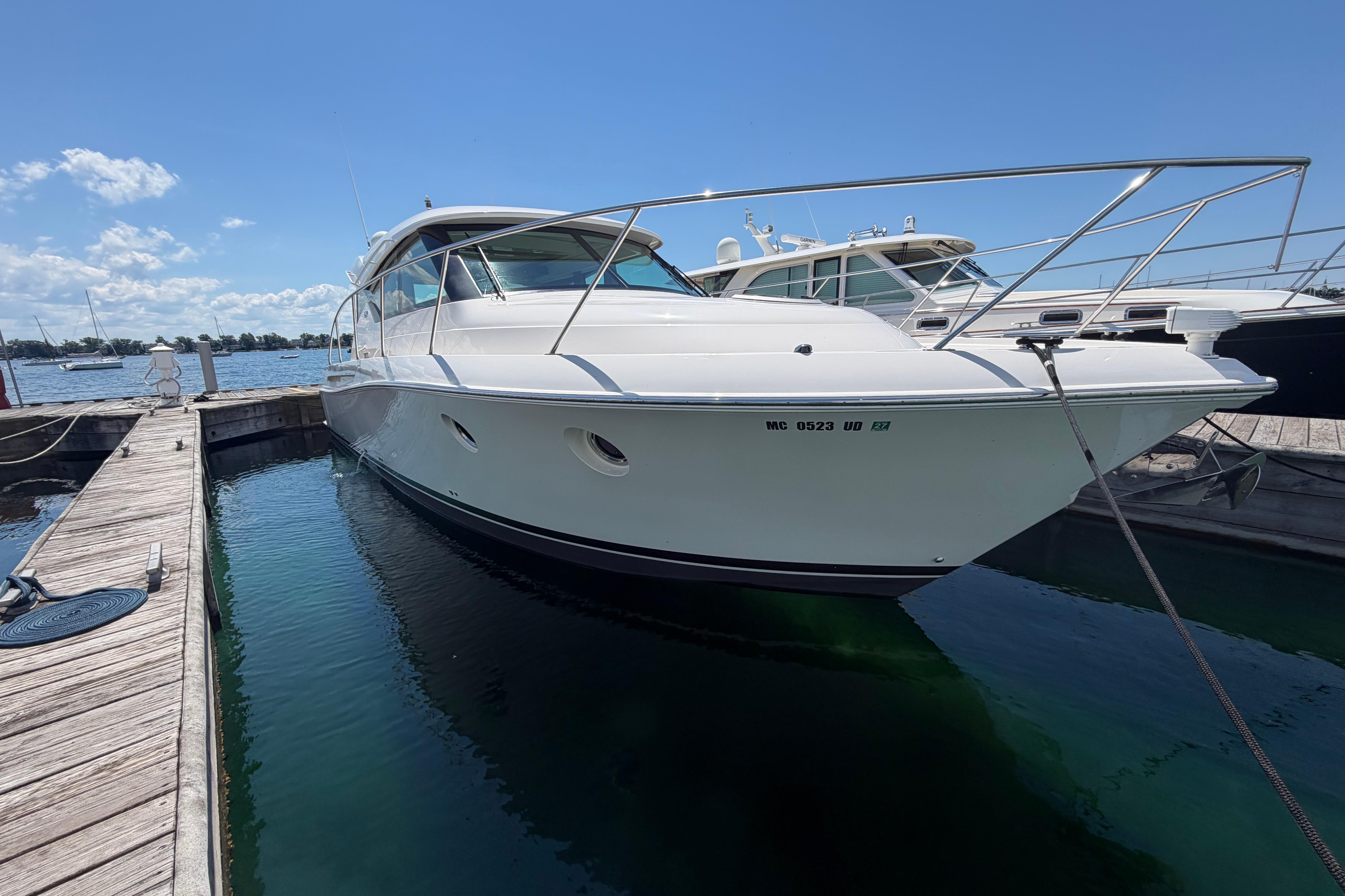 2016 Tiara Yachts C39 Coupe docked at marina under clear blue sky.