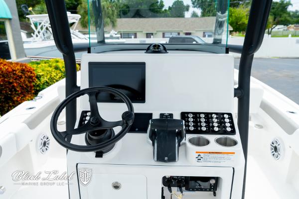 2025 Caymas 281 HB boat dashboard with steering wheel, controls, and display screen.