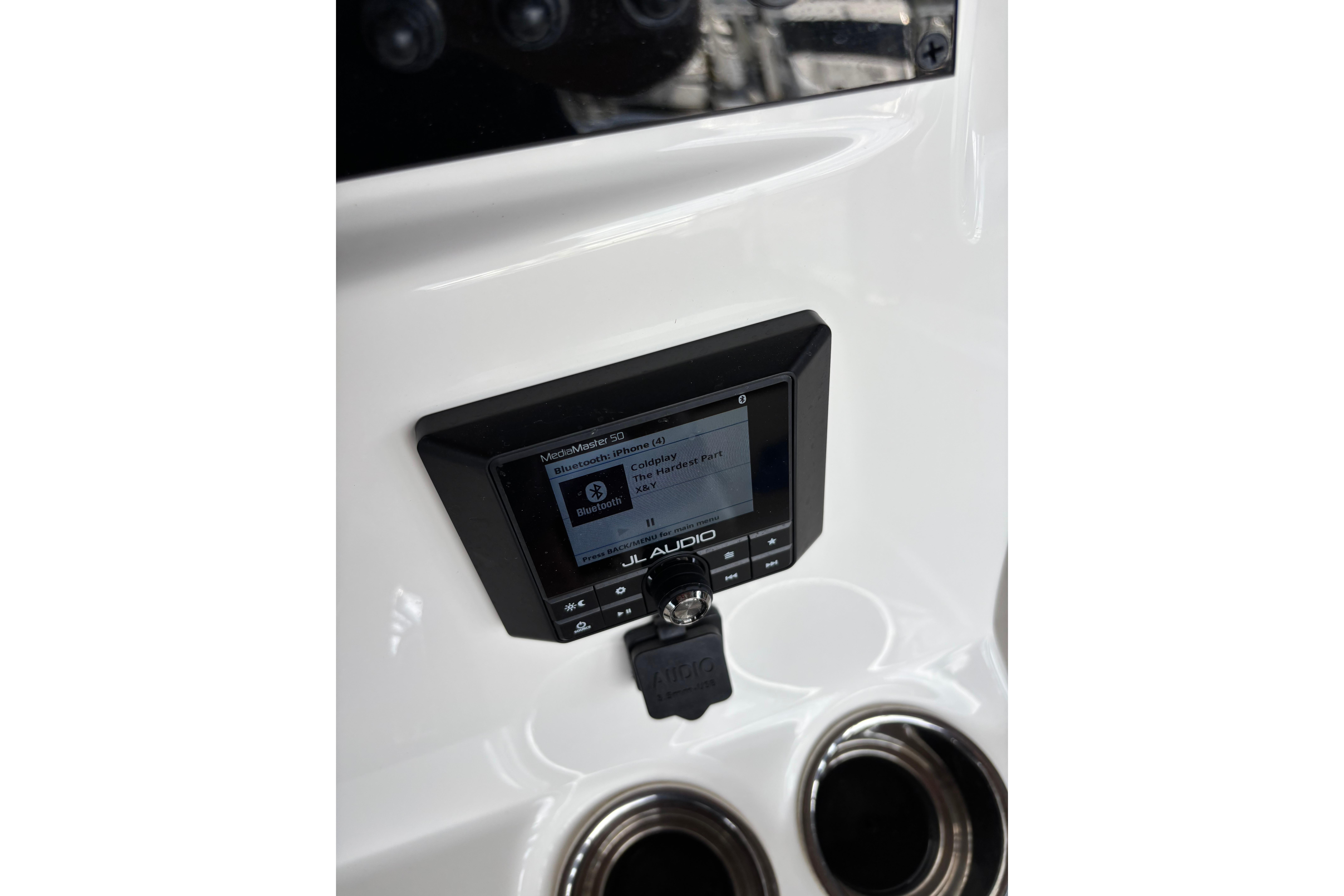 2024 Pioneer 180 Islander boat dashboard with JL Audio system and cup holders.
