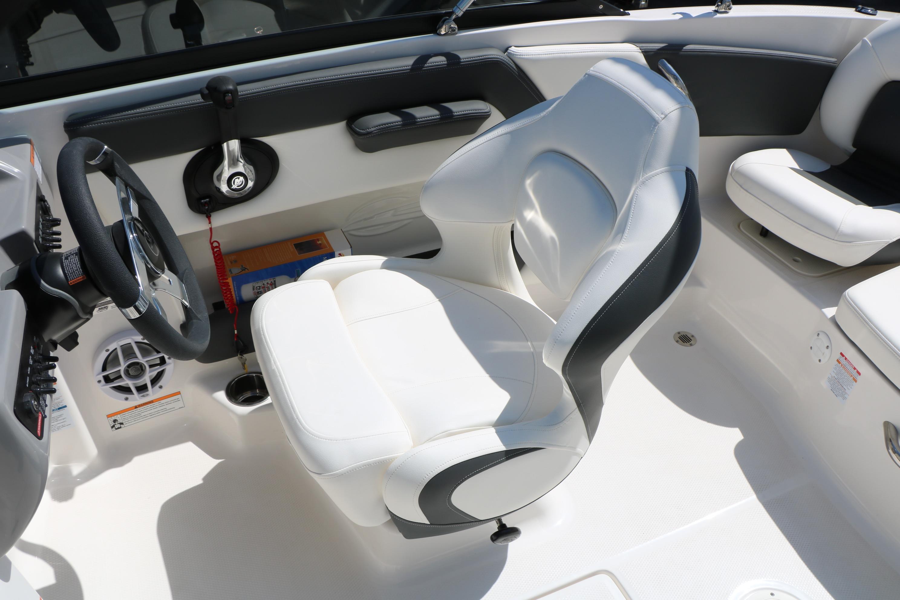 2025 Chaparral 21 SSi Ski & Fish boat interior with white seating and steering wheel.