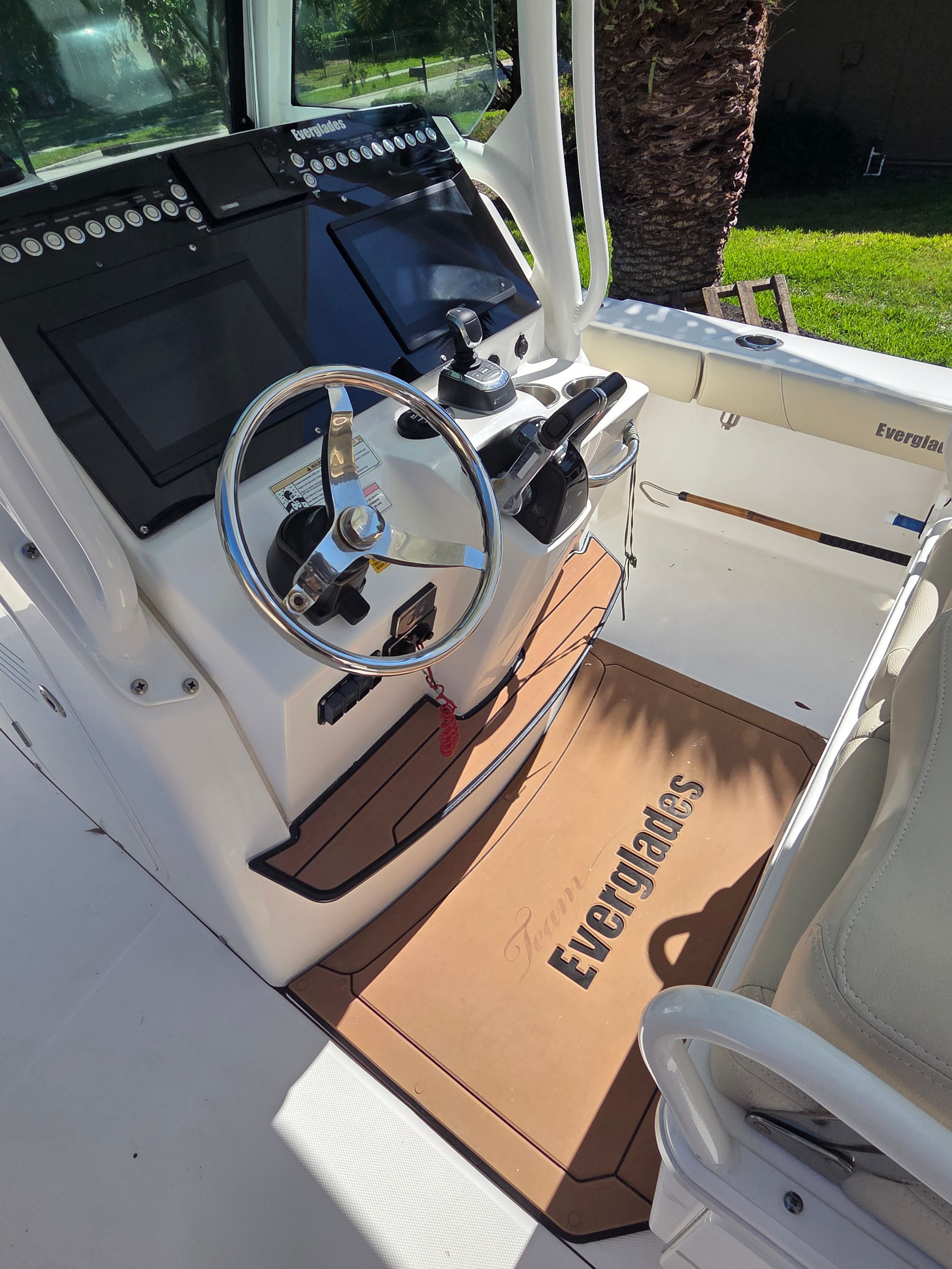 The image shows the helm of a 2017 Everglades 273 Center Console boat with modern instruments.
