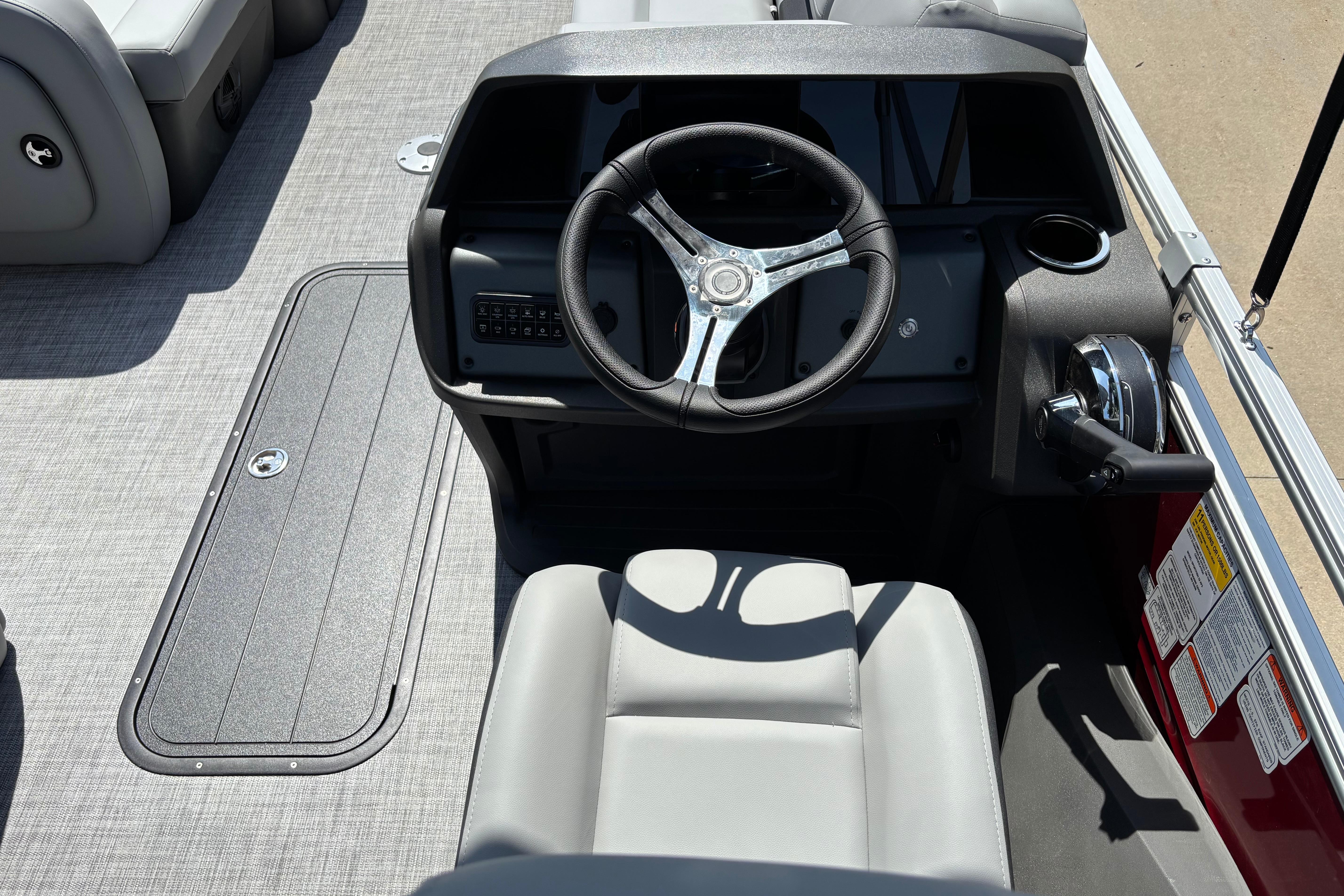 2026 Sun Tracker SportFish 22 XP3 boat cockpit with steering wheel and control panel.