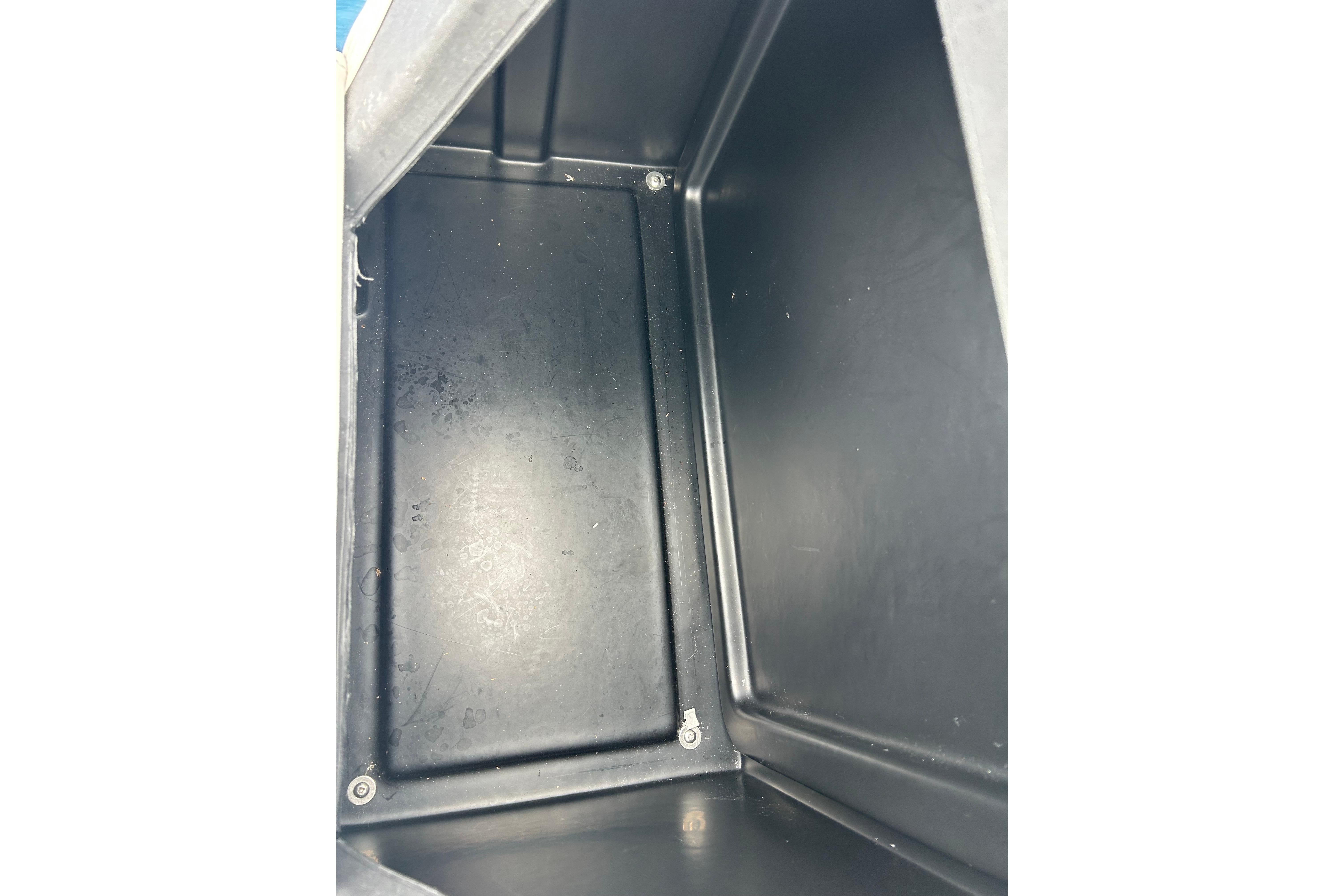 Interior view of a black storage compartment in a 2025 Southbay 224RSLE25.