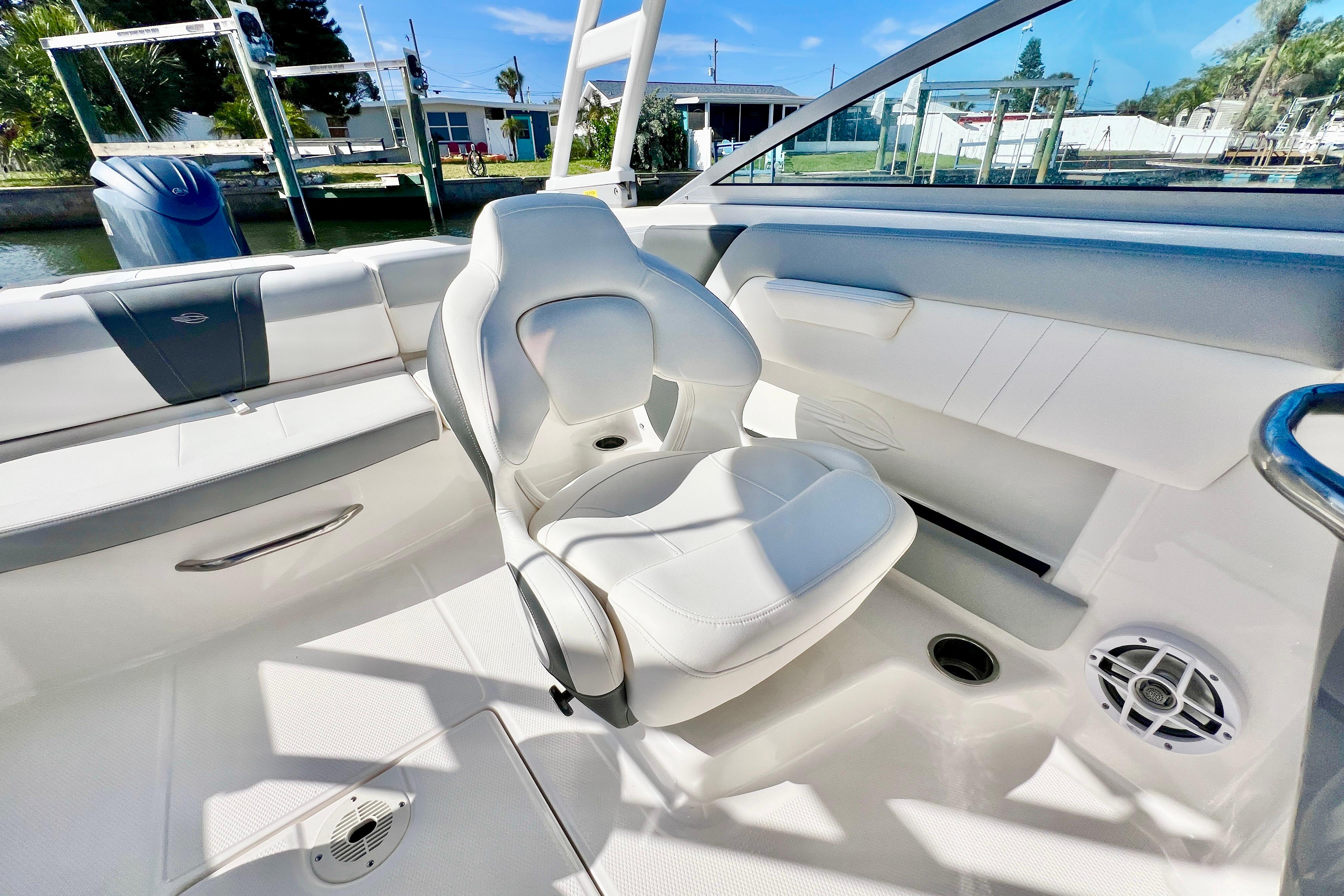 2023 Chaparral 21 SSi OB boat interior with white seating and speaker.