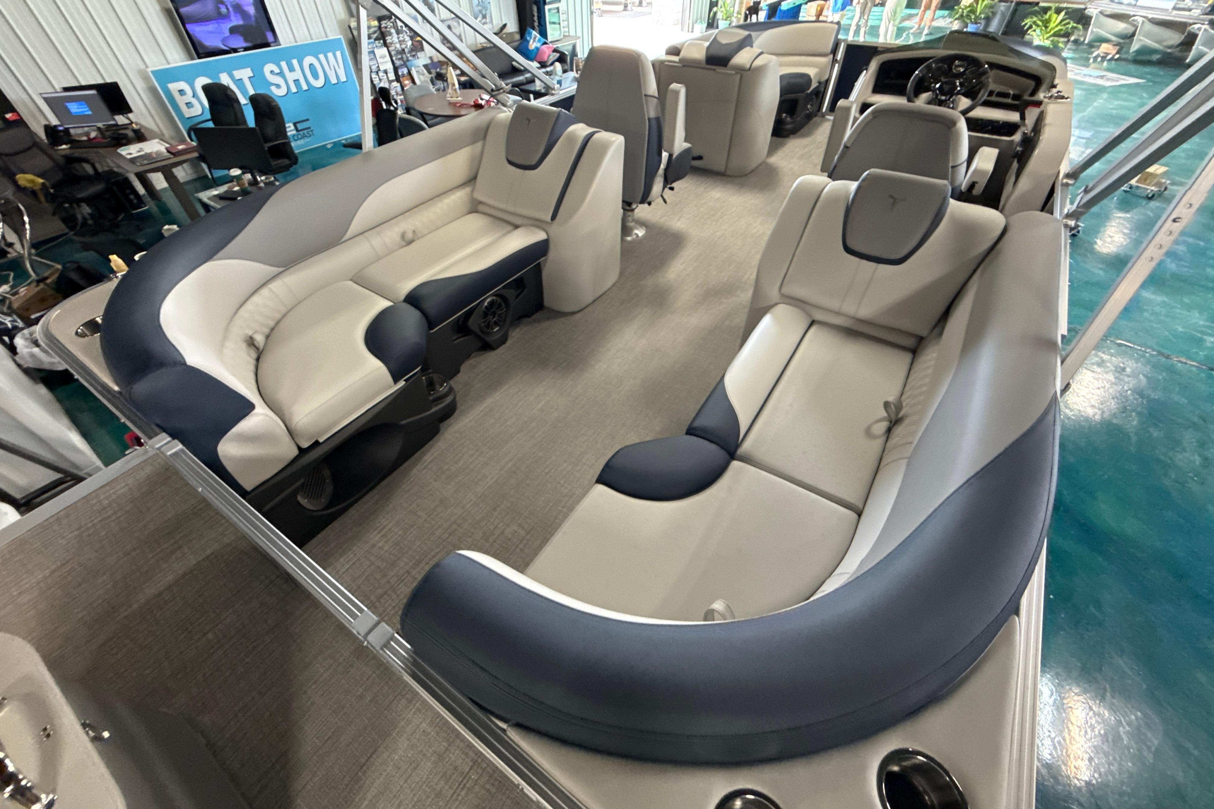 2026 Tahoe Pontoon LTZ Quad Lounger interior with luxurious seating at a boat show.