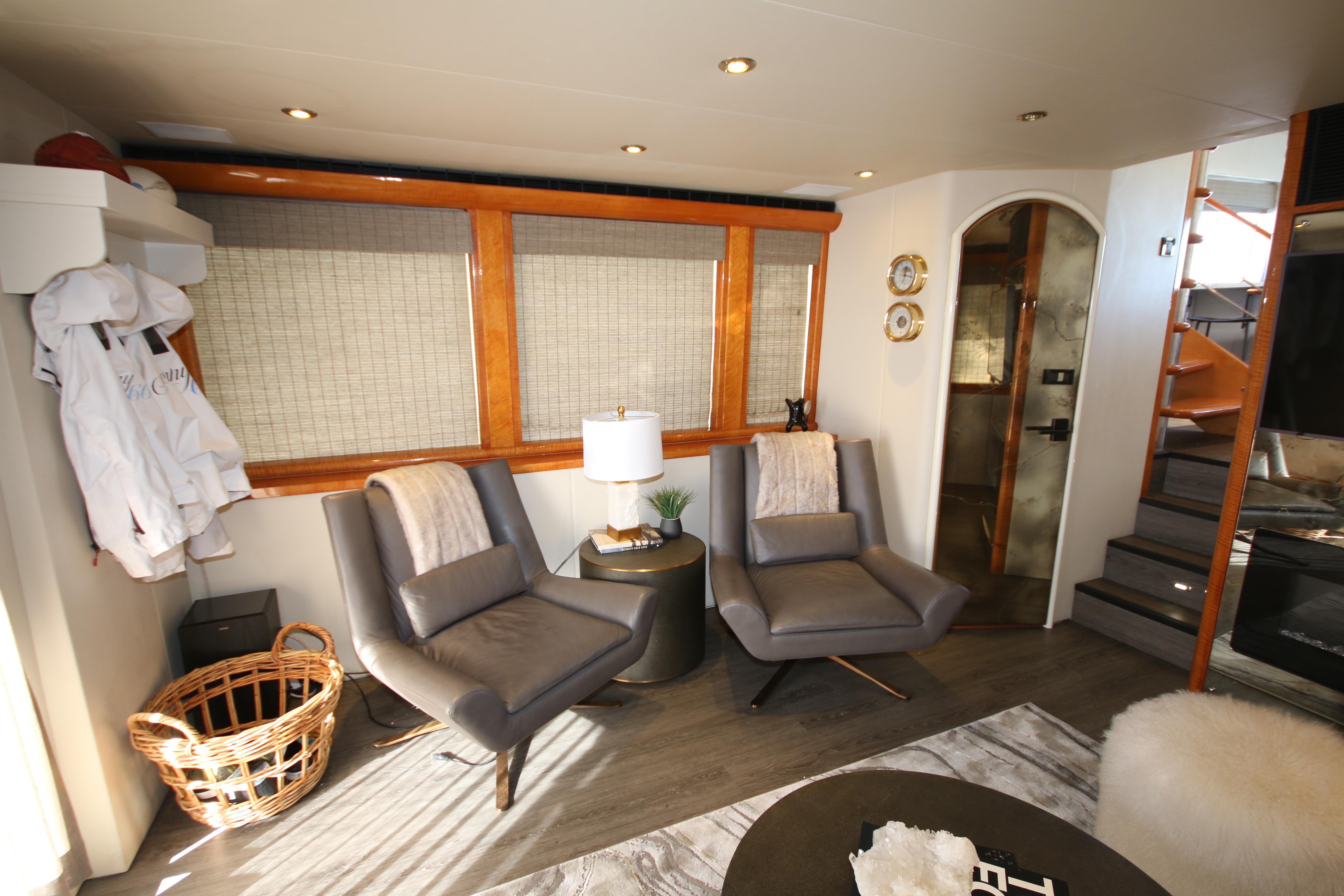 Luxurious interior of 2002 Cheoy Lee 66 Pilothouse yacht with modern seating and decor.