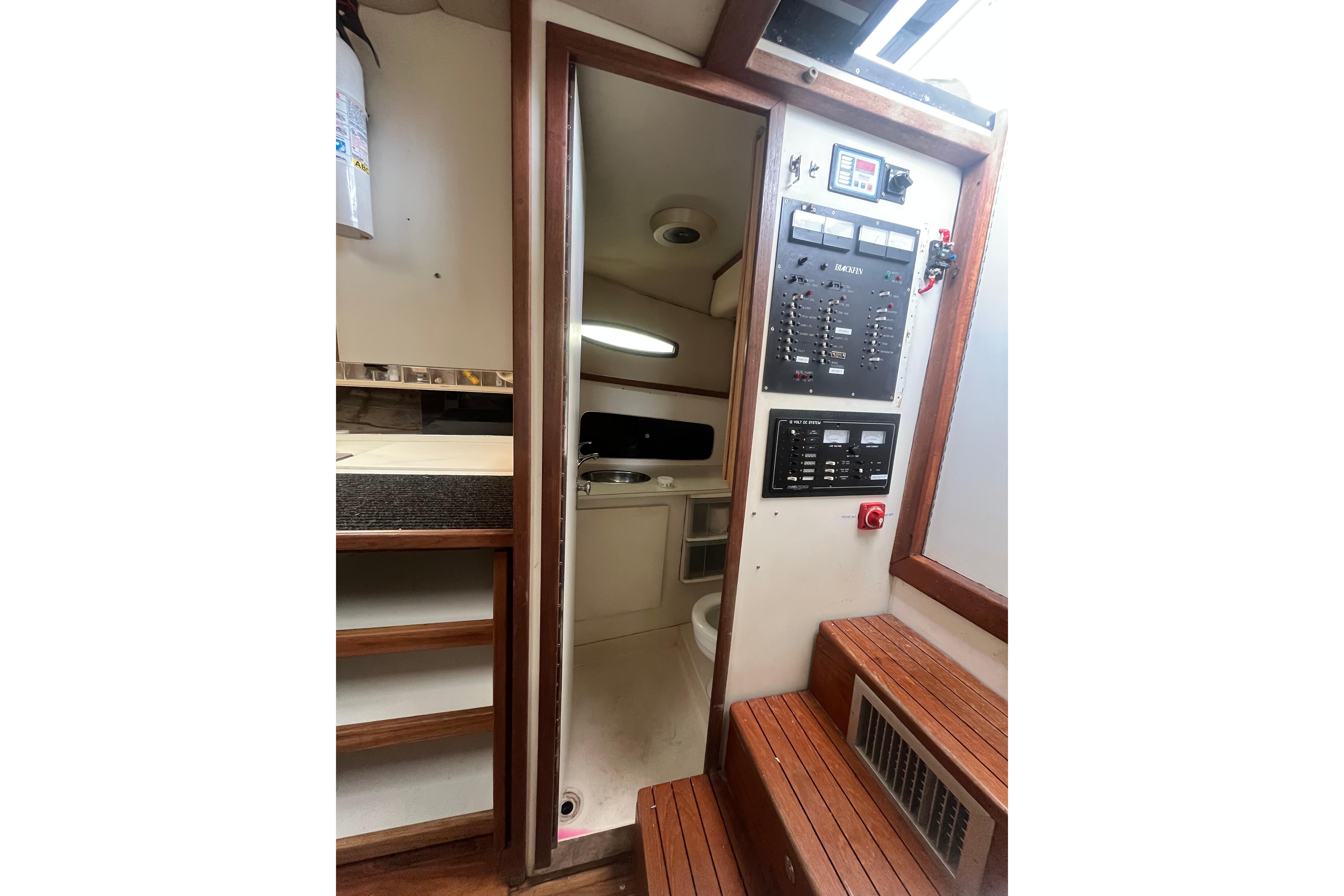 Interior of 1989 Blackfin 31 Combi boat showing control panel and cabin entrance.