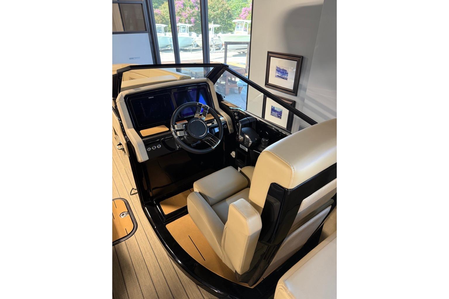Interior of 2026 Balise Halo 26C Twin boat with modern steering and beige seating.