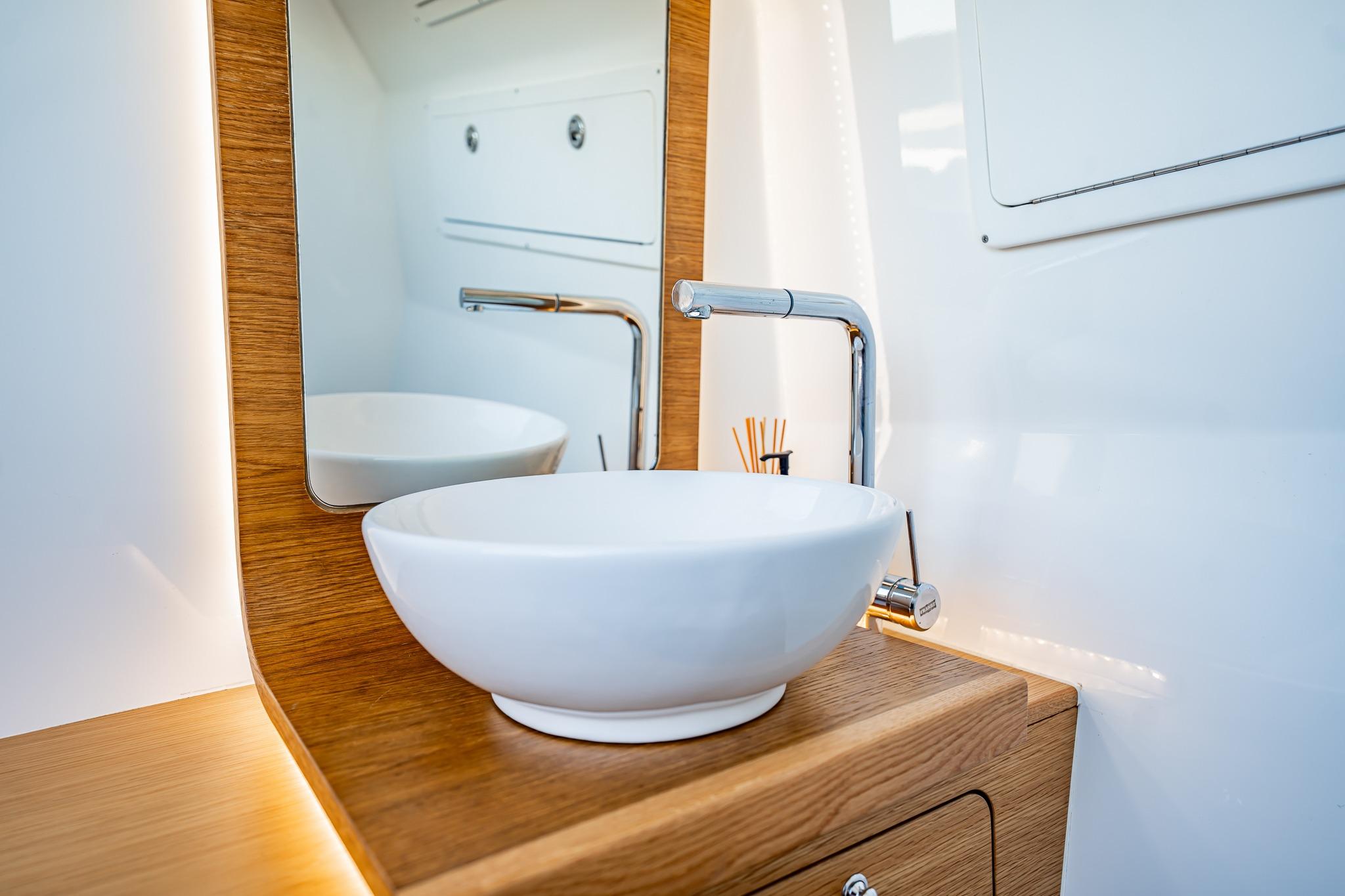 Modern bathroom sink with wooden accents on Skipper-BSK 38NC, 2023 model.