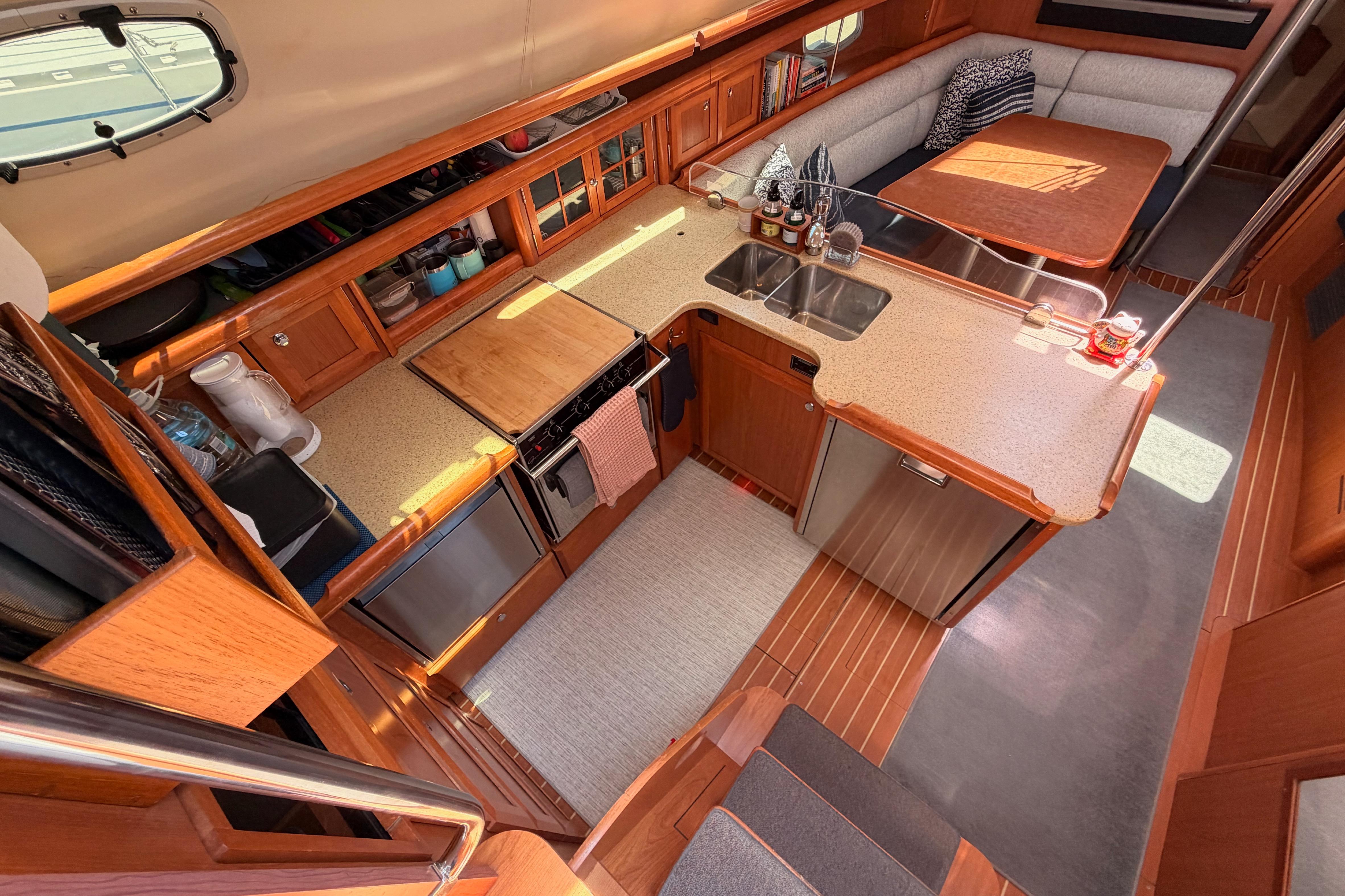 Luxurious interior of 2008 Hunter 45 Deck Salon yacht with modern kitchen and dining area.