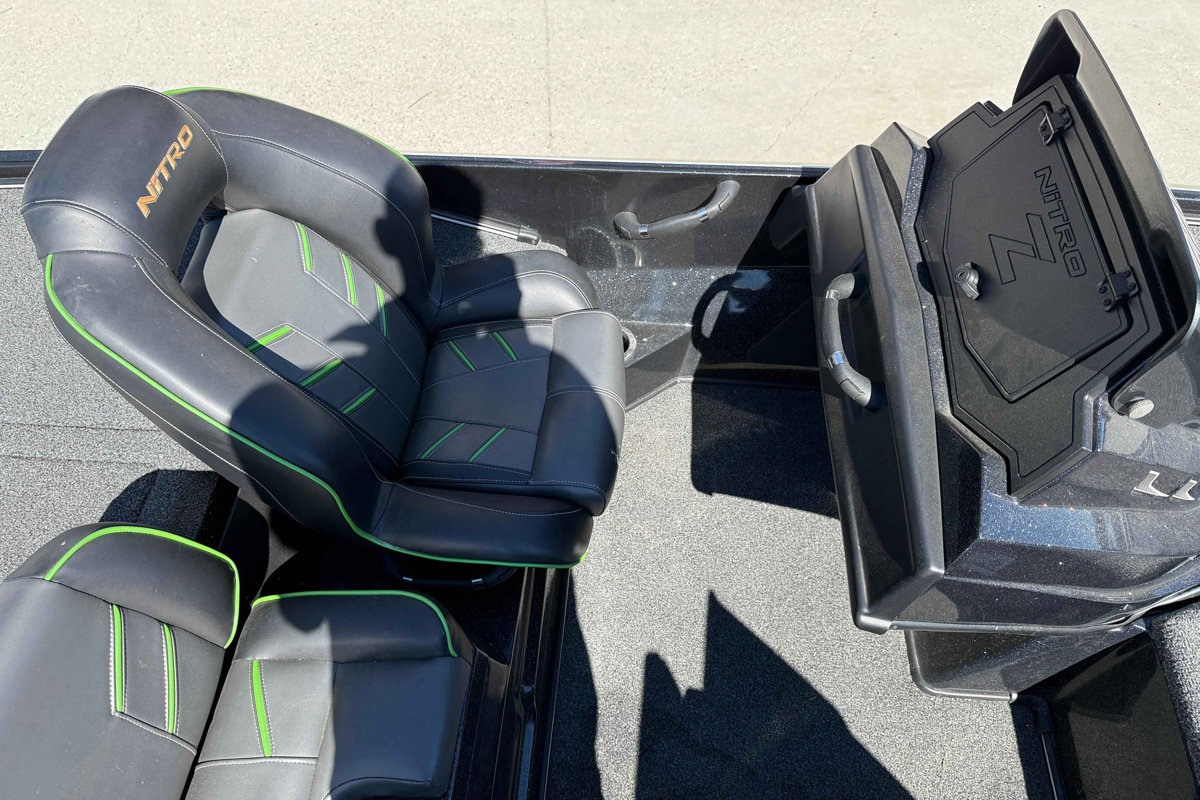 Nitro Z20 2020 boat interior with black and green seats and storage compartment.