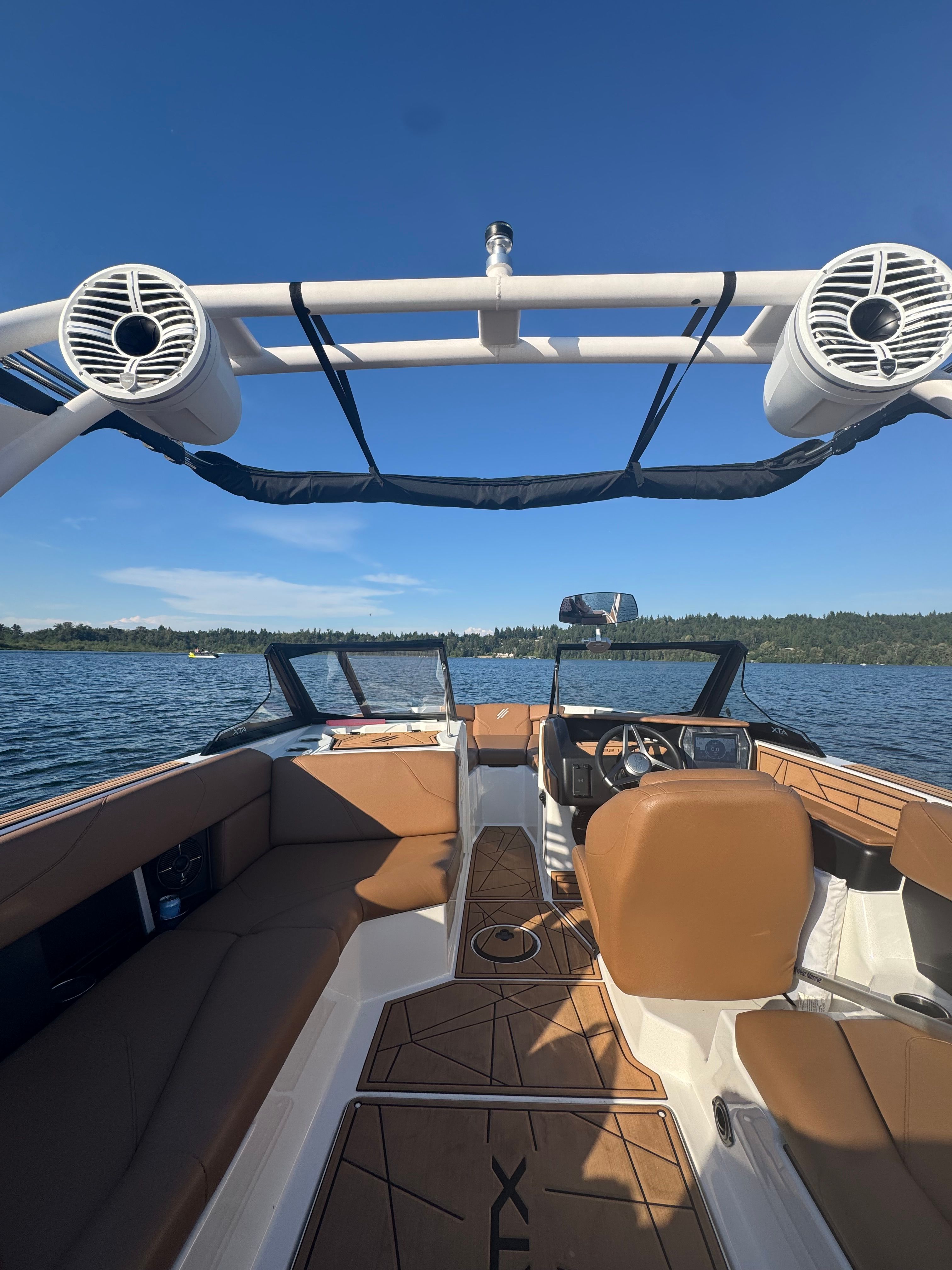 2022 ATX Surf Boats 22 Type-S on a calm lake with clear skies.