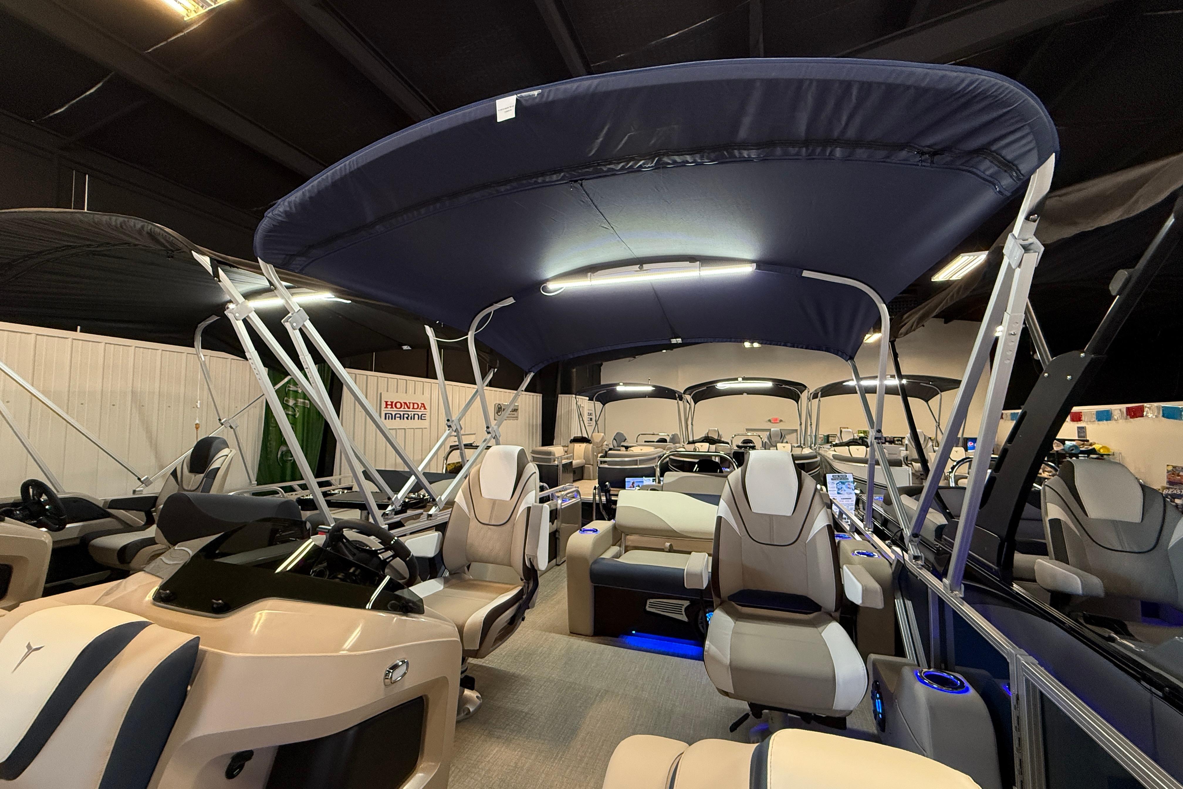 2026 Tahoe Pontoon LTZ Quad Lounger Shift with canopy and luxurious seating in showroom.