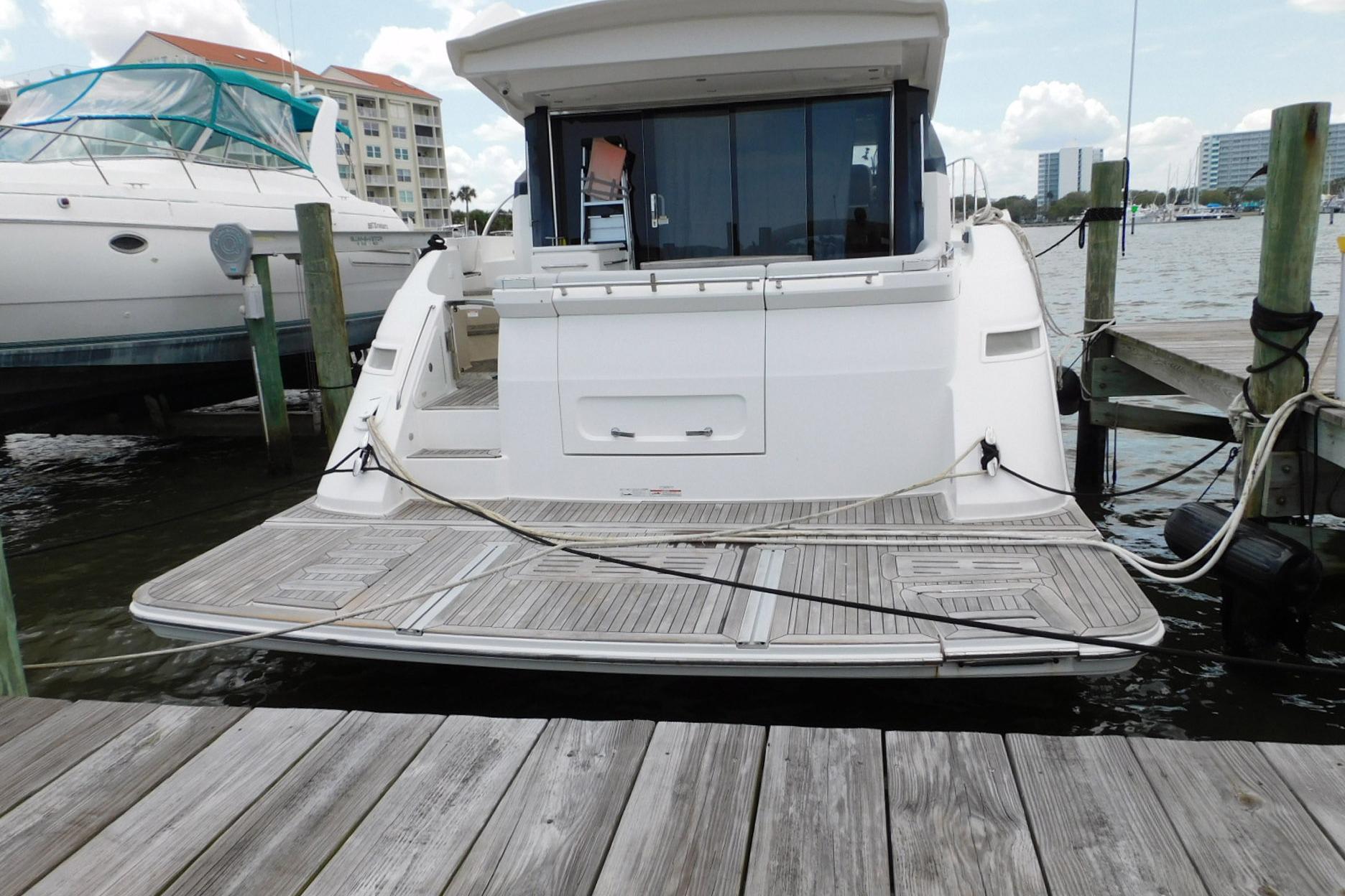 2019 Sea Ray L550 yacht docked at marina, showcasing spacious rear deck.