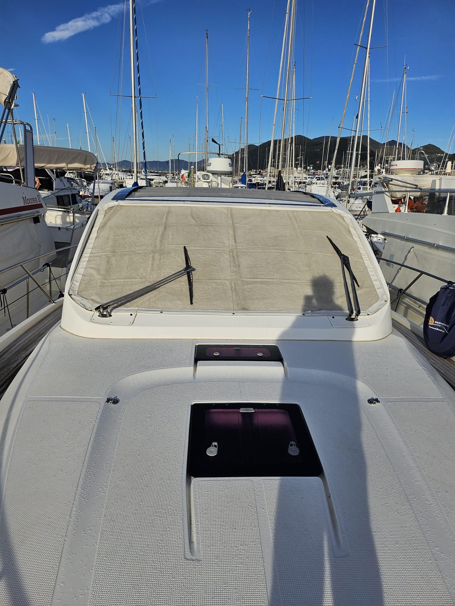 2013 Bavaria 38 HT Sport yacht docked at marina with clear blue sky.