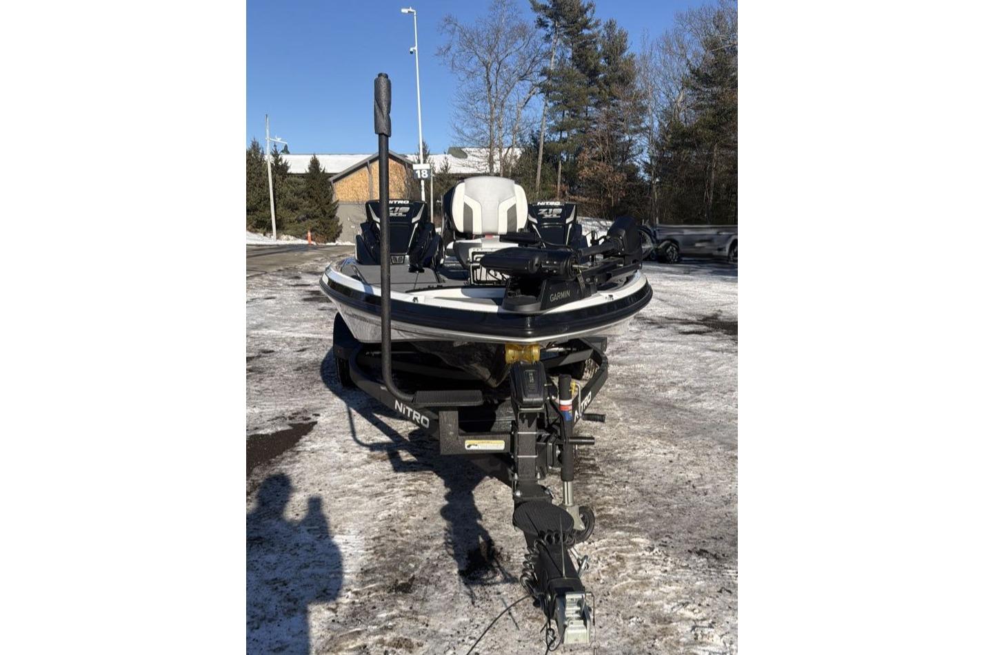 2026 Nitro Z19 XL Pro boat on snowy ground, front view with trees in background.