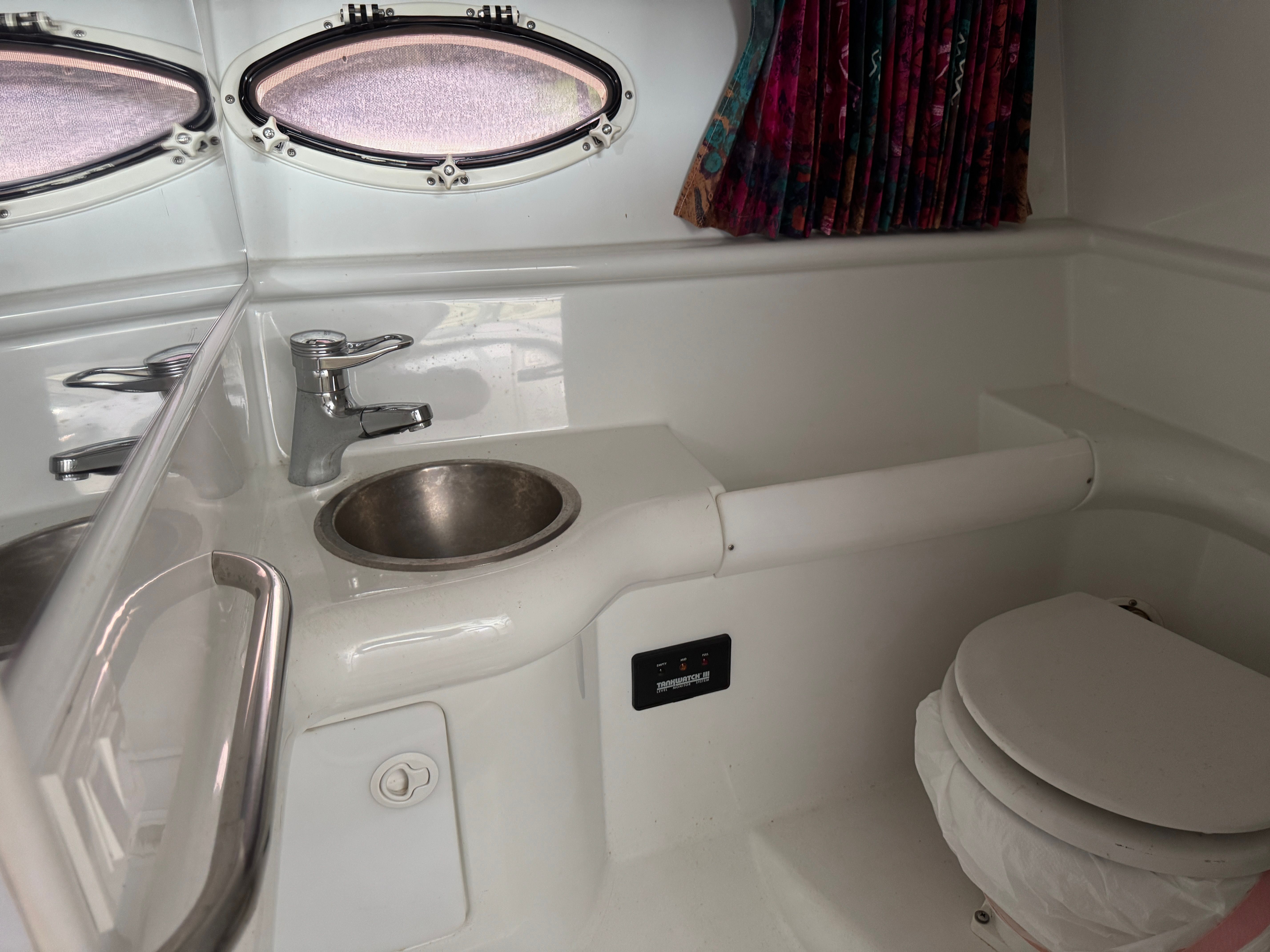 Interior of a 1997 Formula 330 Sun Sport yacht with sink and toilet.
