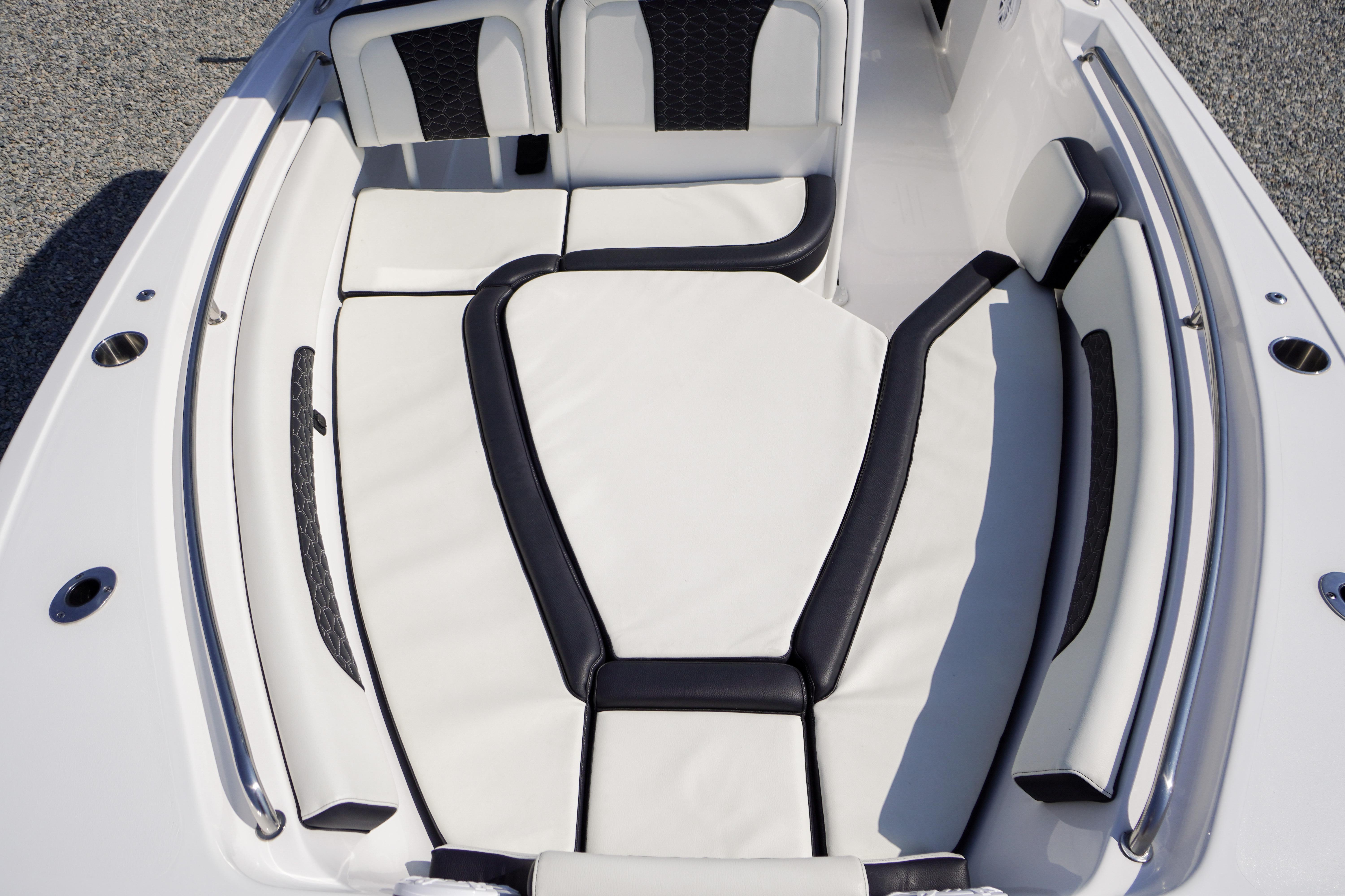 2025 Tidewater 232 SS boat interior with white and black cushioned seating.