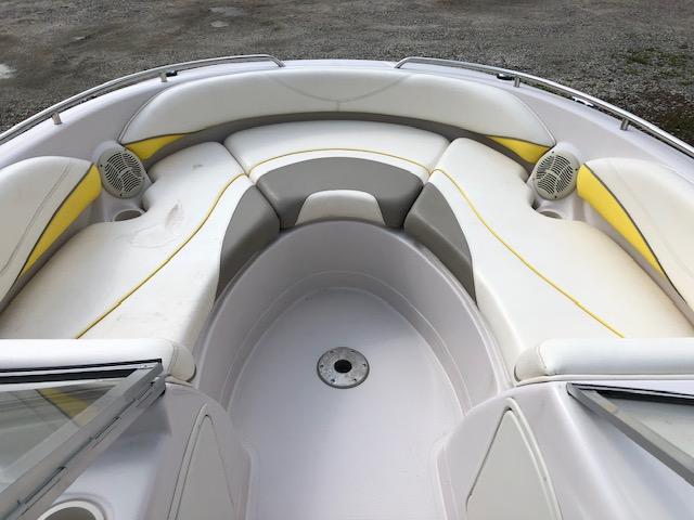 2005 Tahoe Q4 I/O boat interior with white and yellow cushioned seating.