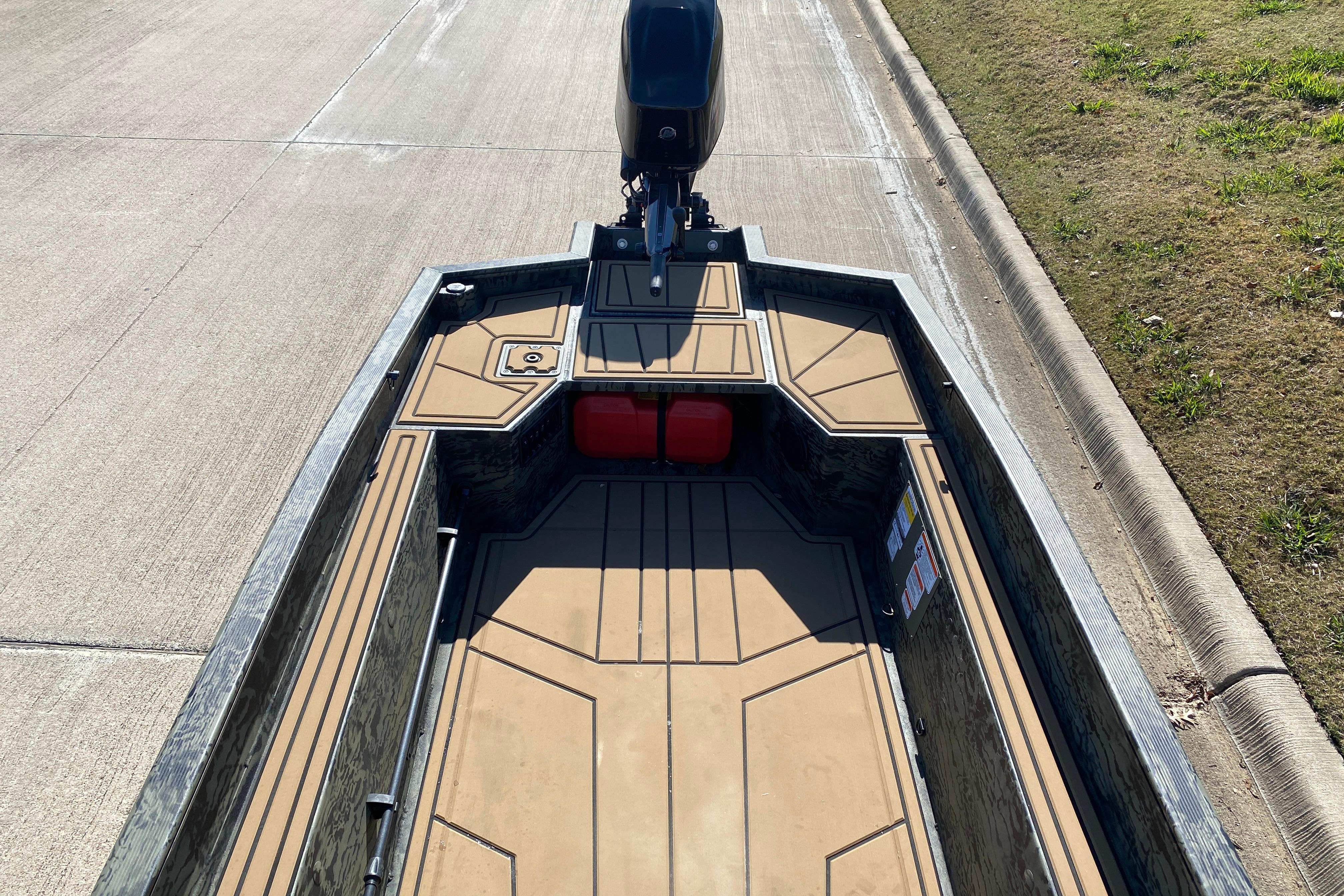 2026 Tracker Grizzly 1650 T Prairie Wings Edition boat on a paved road.