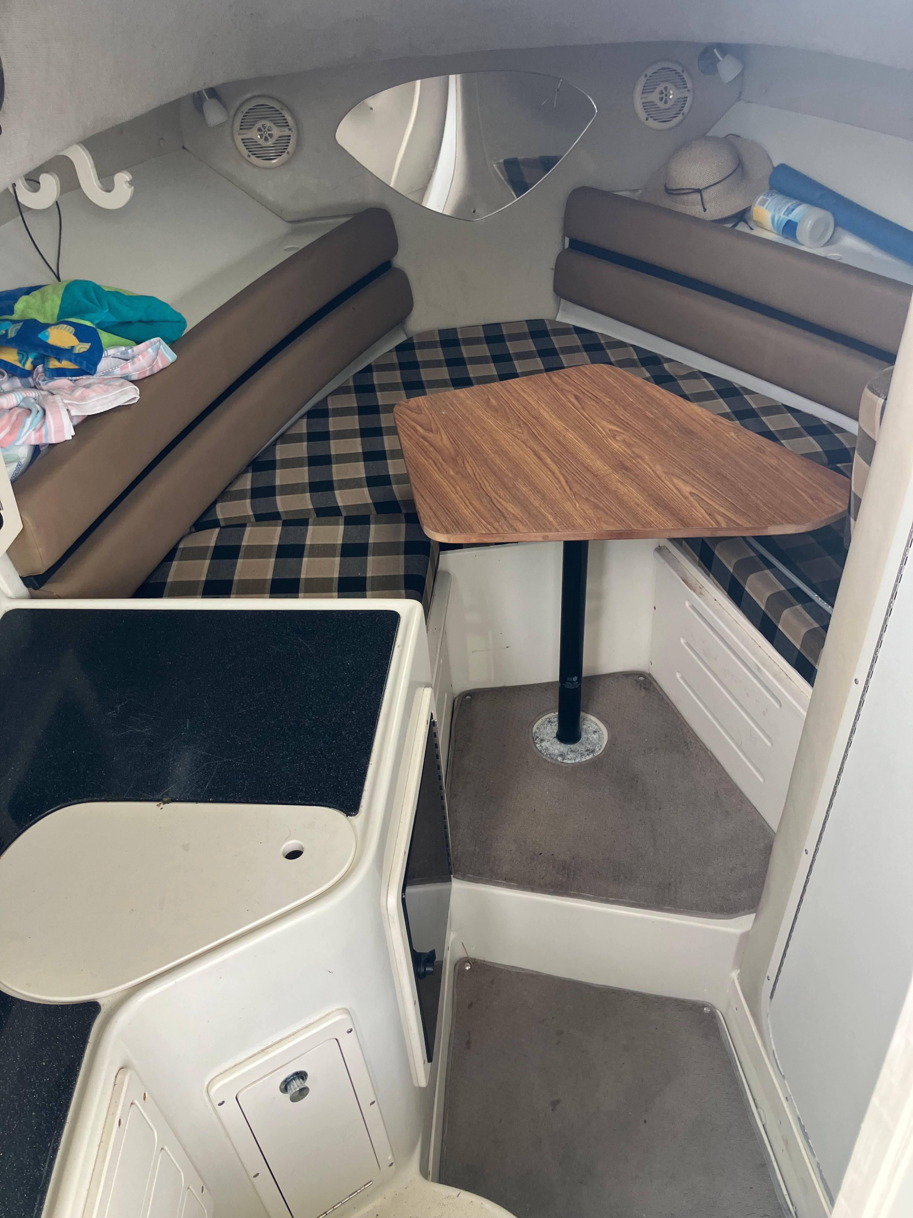 Interior of 2002 Hydra-Sports Vector 2600 WA with table and seating area.
