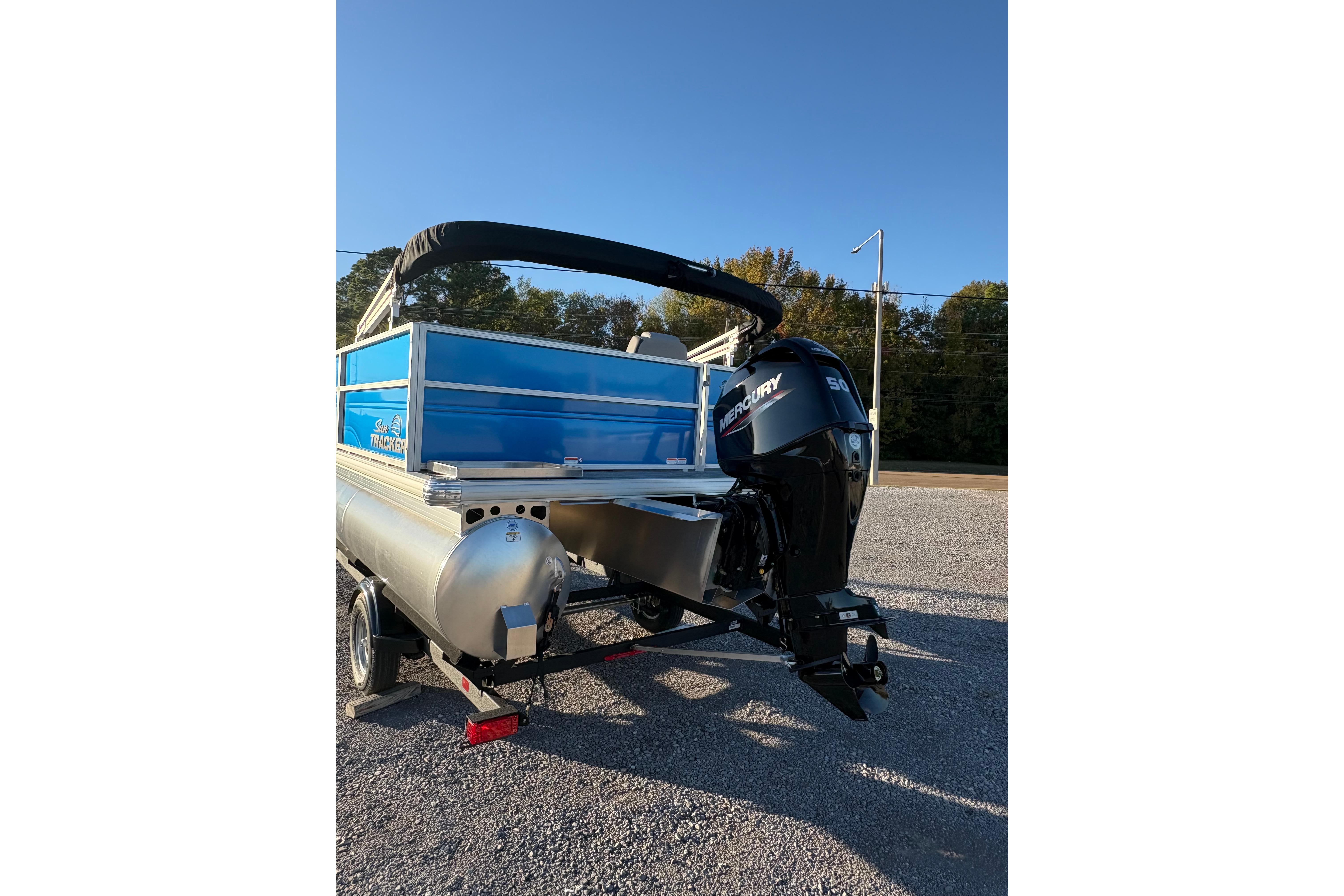2026 Sun Tracker Party Barge 16 DLX pontoon boat with Mercury outboard motor.