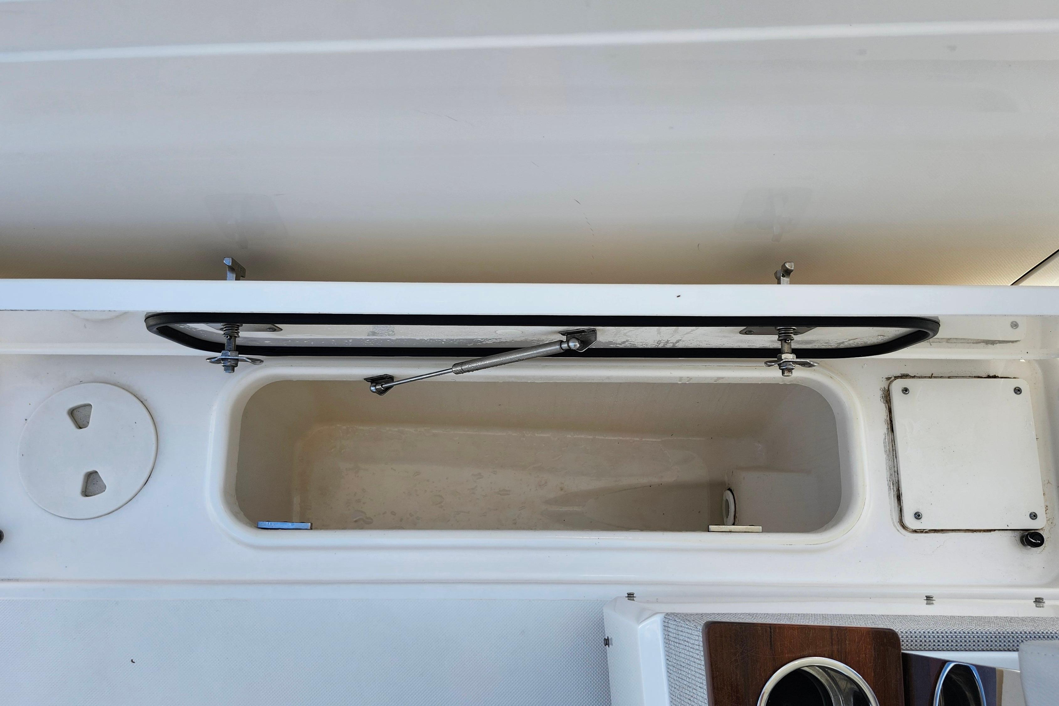 Open storage compartment on a 2022 Tiara Yachts 38 LS boat.