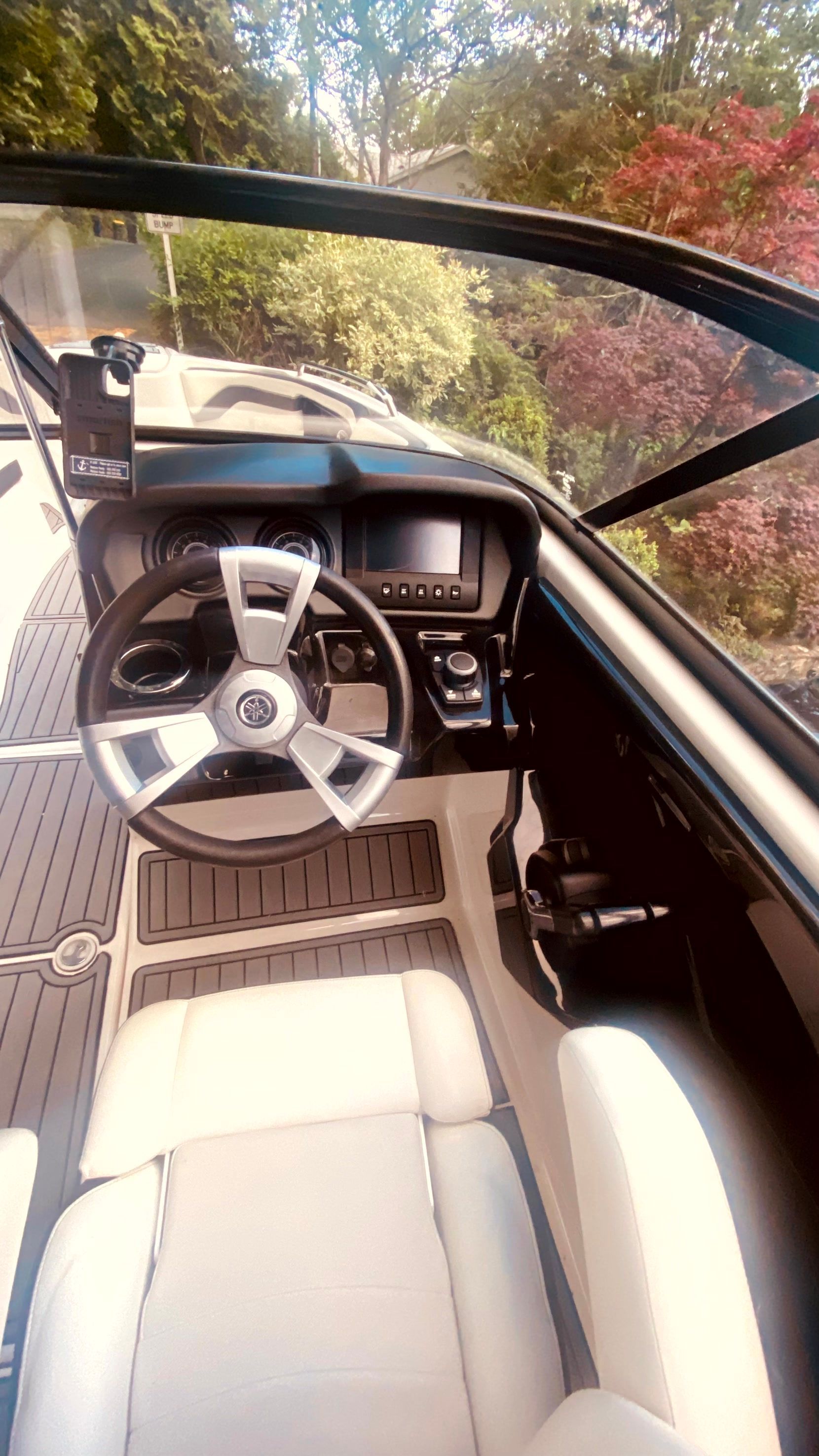 Interior of a 2016 Yamaha AR240 boat with steering console.