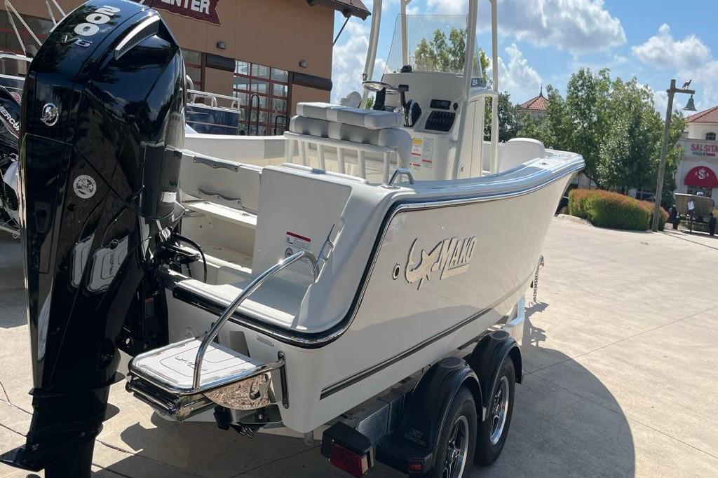 2026 Mako 214 Center Console boat with powerful outboard motor on trailer.