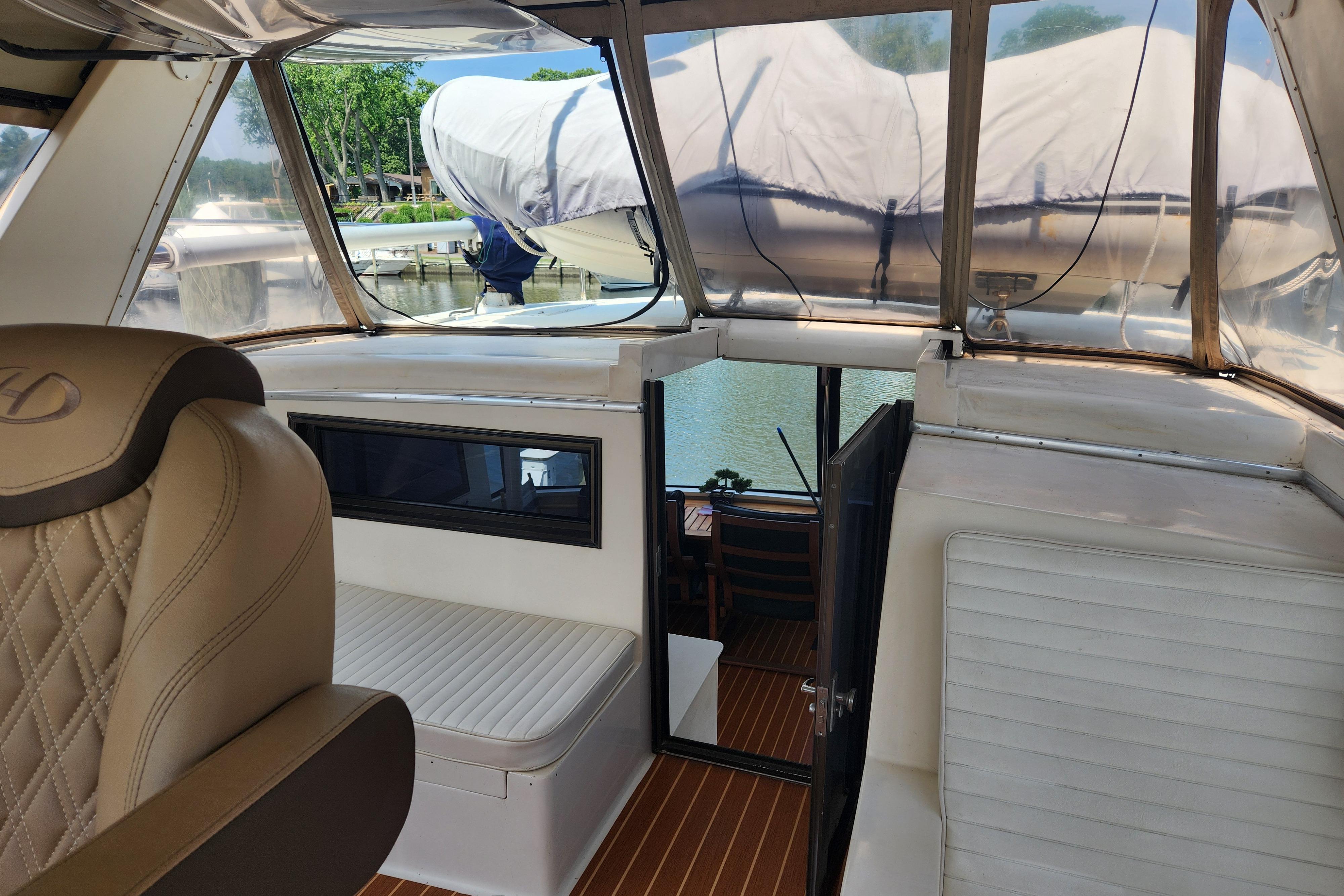 1989 Hyatt Double Cabin Motoryacht interior with leather seating and view of marina.