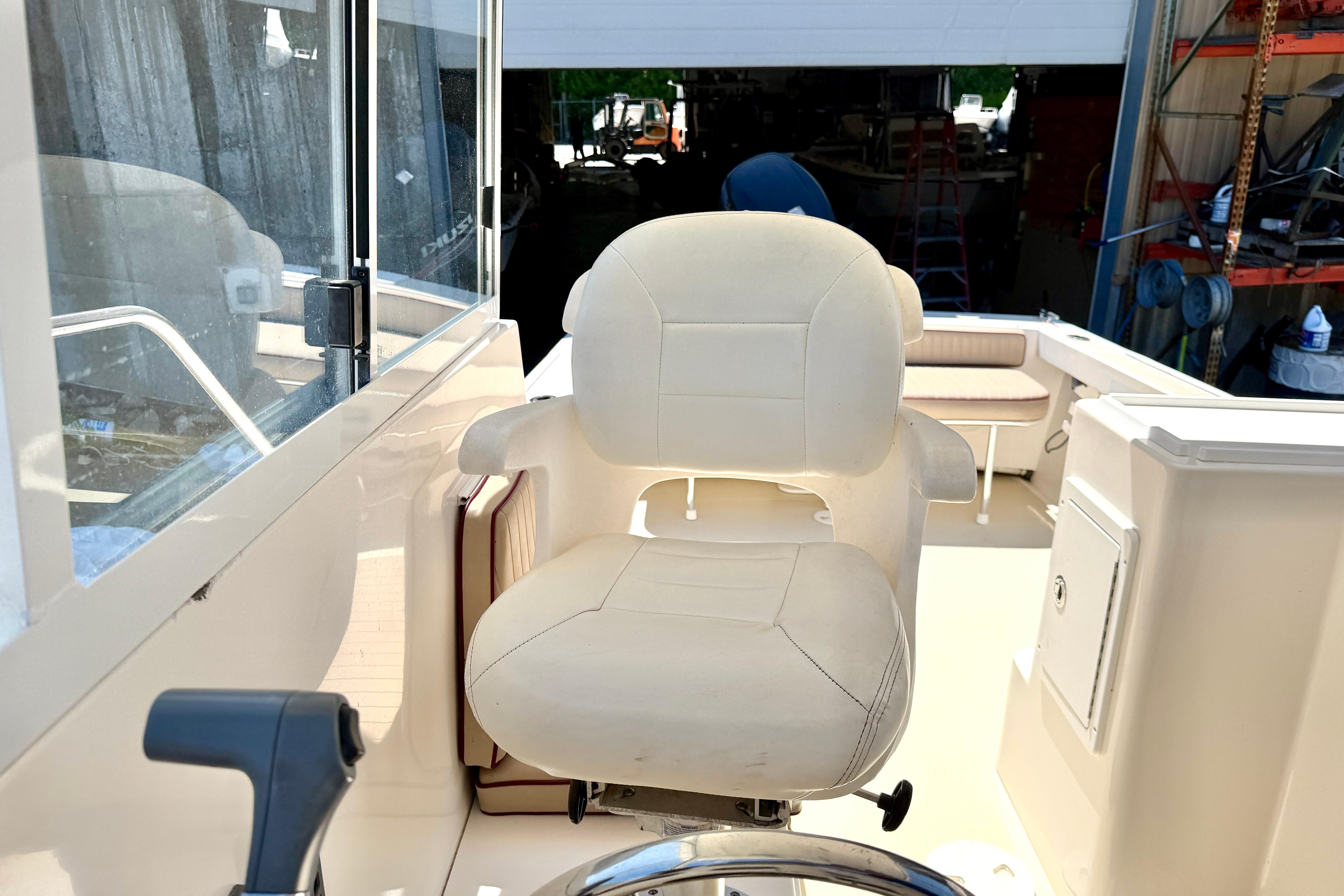 Captain's chair on a 2005 Grady-White Freedom 225 boat, showcasing helm area.