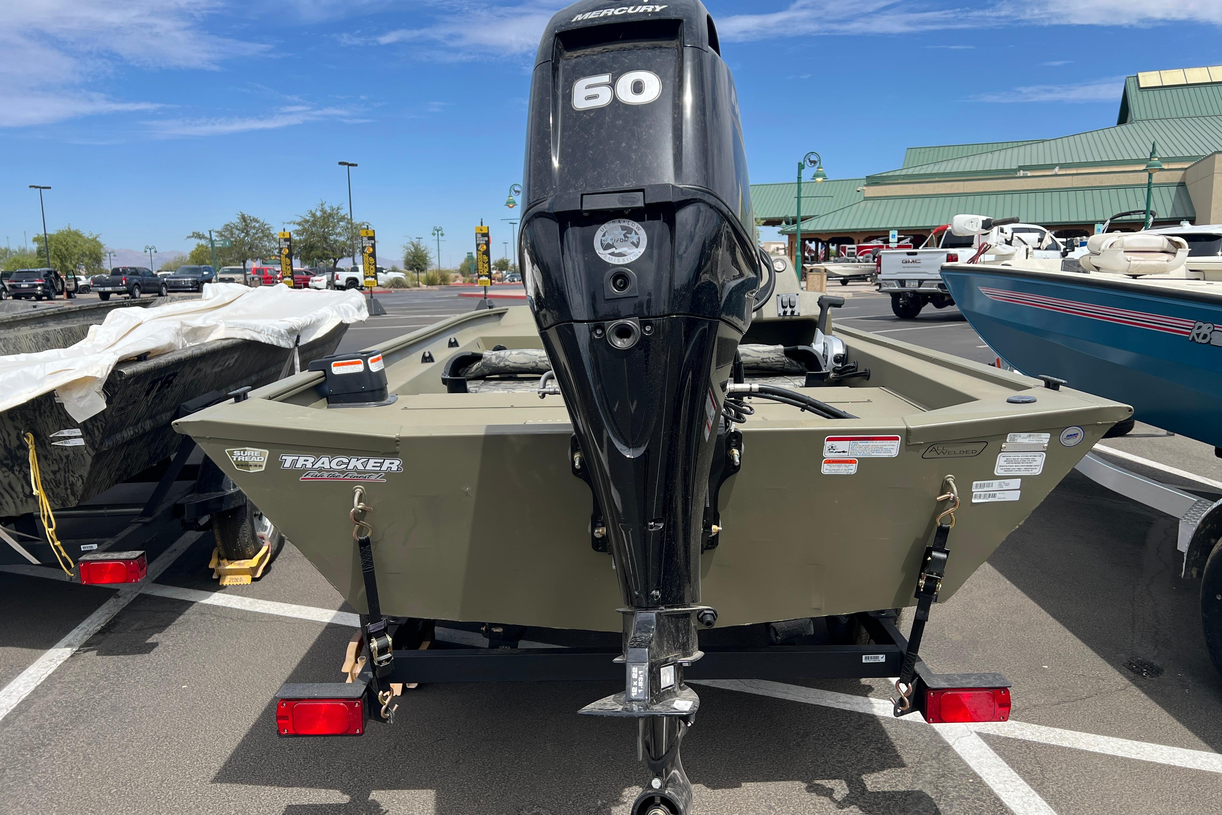 2026 Tracker Grizzly 1754 SC boat with Mercury 60 engine in parking lot.