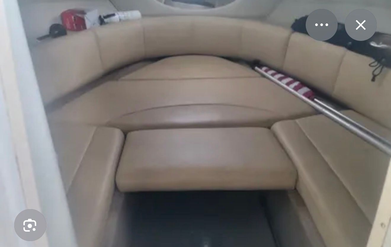 Interior of the 2007 Chaparral 235 SSi with beige upholstery and storage space.