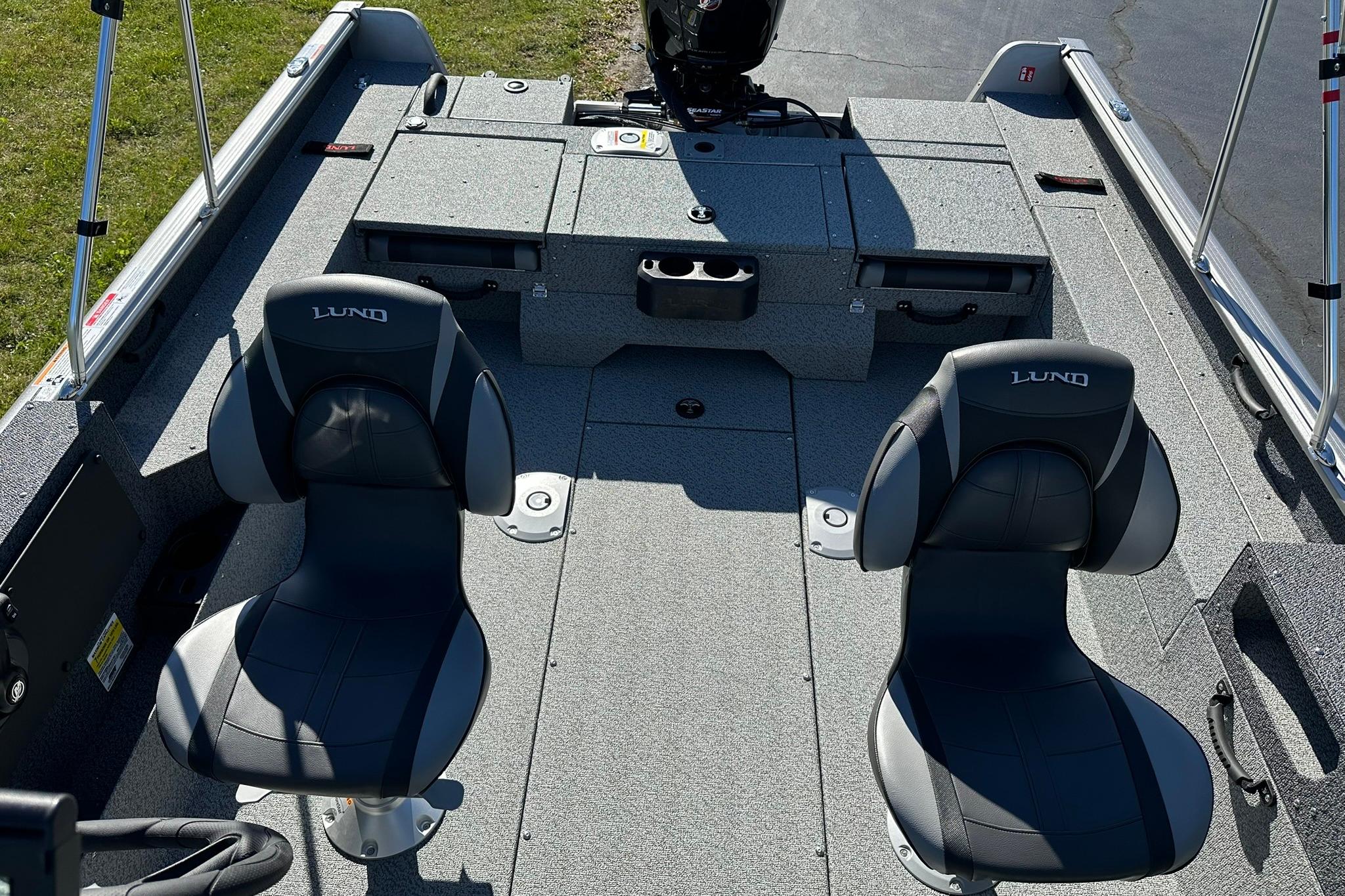 2026 Lund 1875 Impact XS Sport boat interior with two cushioned seats and storage compartments.