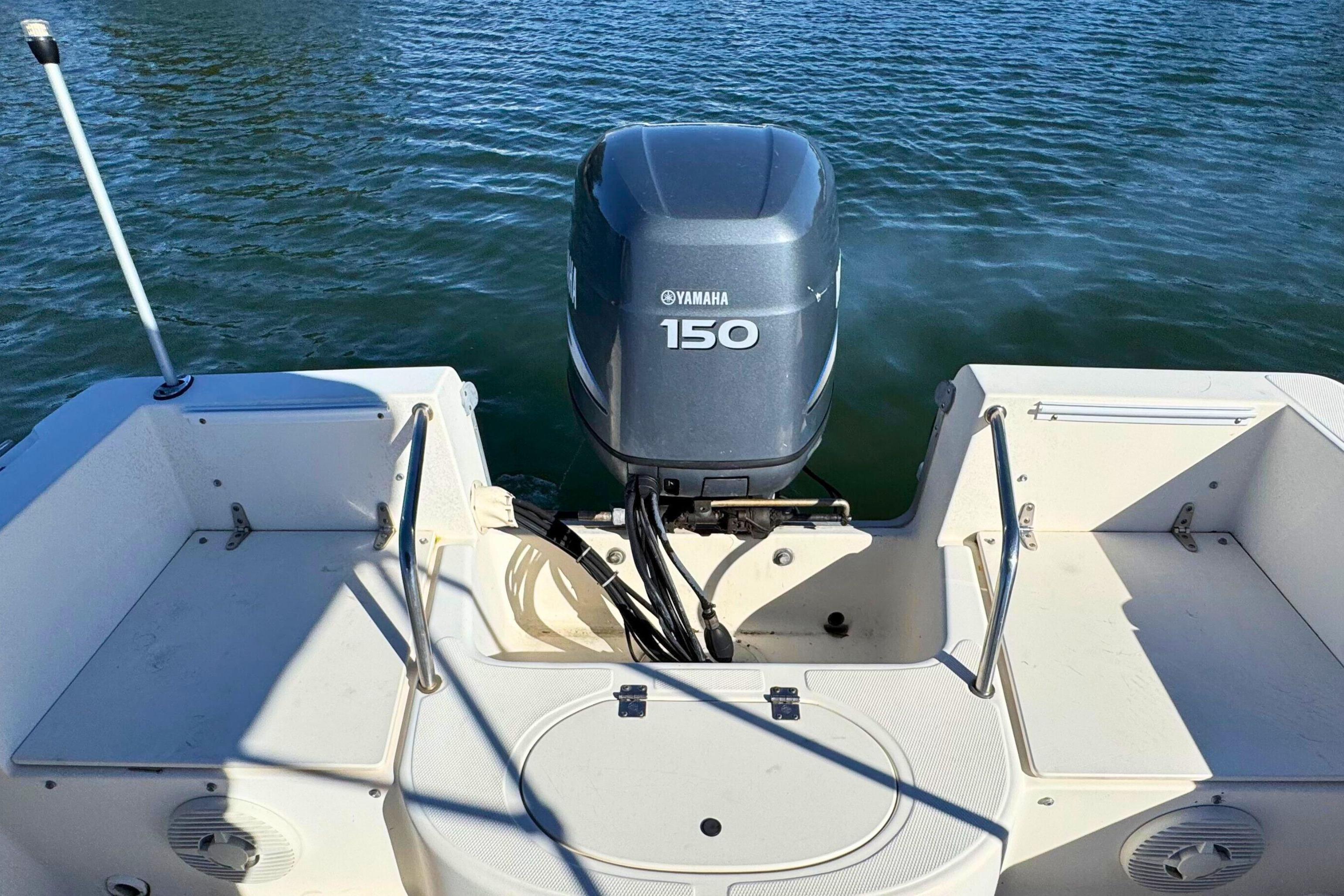 2002 Sea Hunt Escape 200 boat with Yamaha 150 engine on calm water.