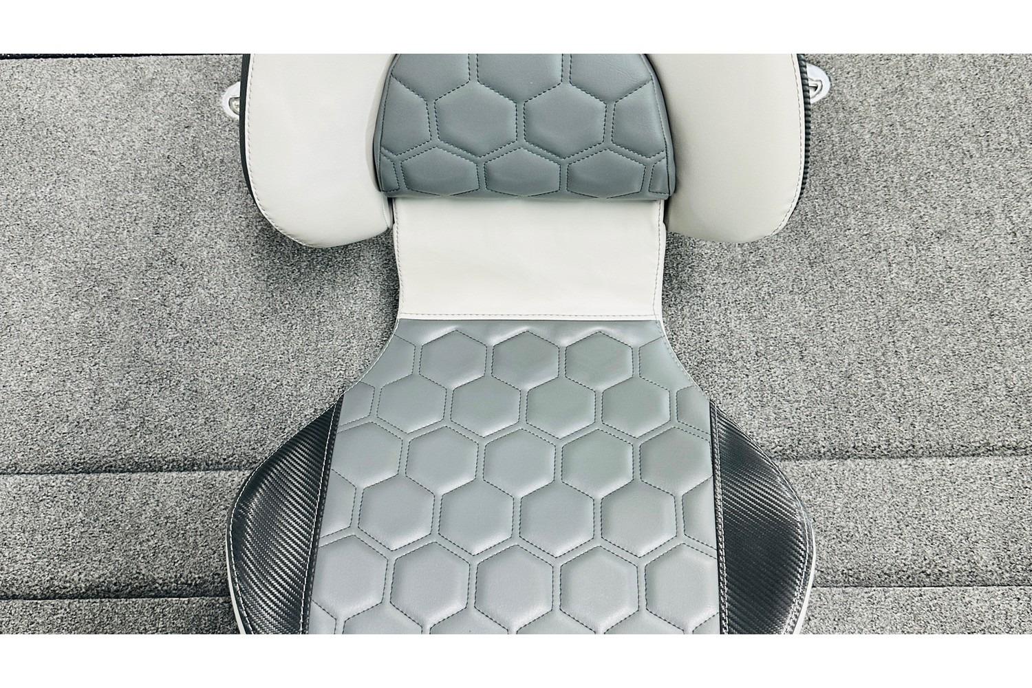 2026 Bass Cat Lynx STS seat with hexagonal pattern and carbon fiber accents.