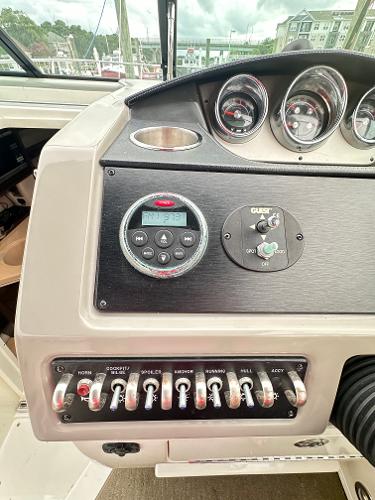 Control panel of a 2015 Sea Ray 260 Sundancer boat with gauges and switches.