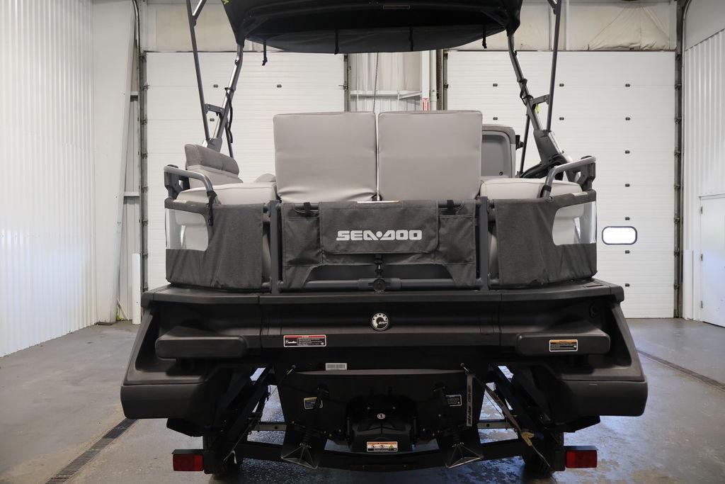 2023 Sea-Doo Switch Sport Compact in a garage, rear view showcasing seating and design.