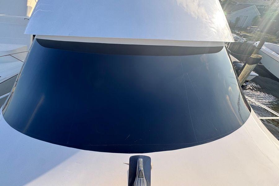 2002 Viking 61 Enclosed Bridge yacht with sleek tinted windows.